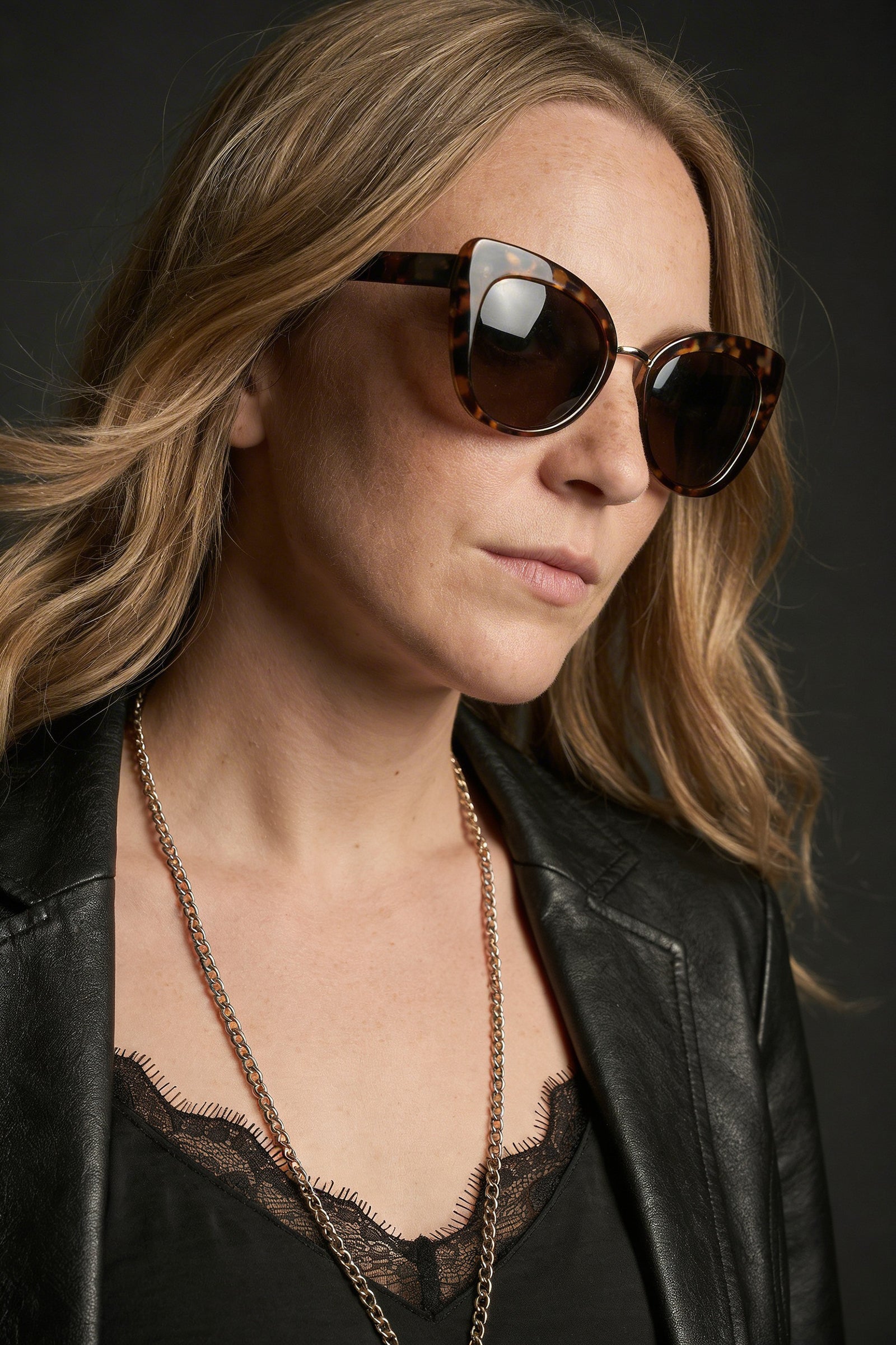 Model wearing tortoiseshell cat eye retro sunglasses styled with Nightbird Satin slip Dress