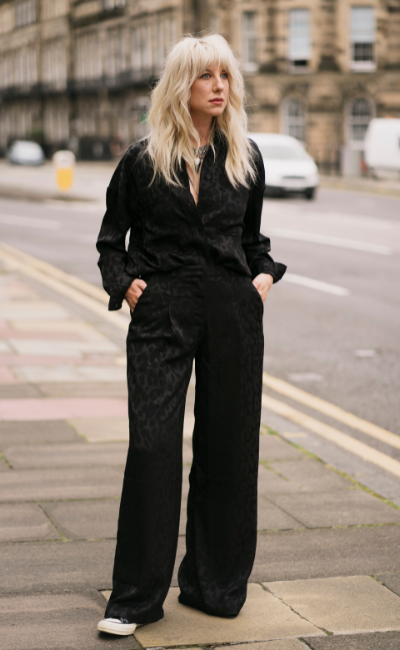 Sara wearing theSweet Emotion Oversized Shirt paired with the Sweet Emotion Wide Leg Trouser and converse trainers, street styling.