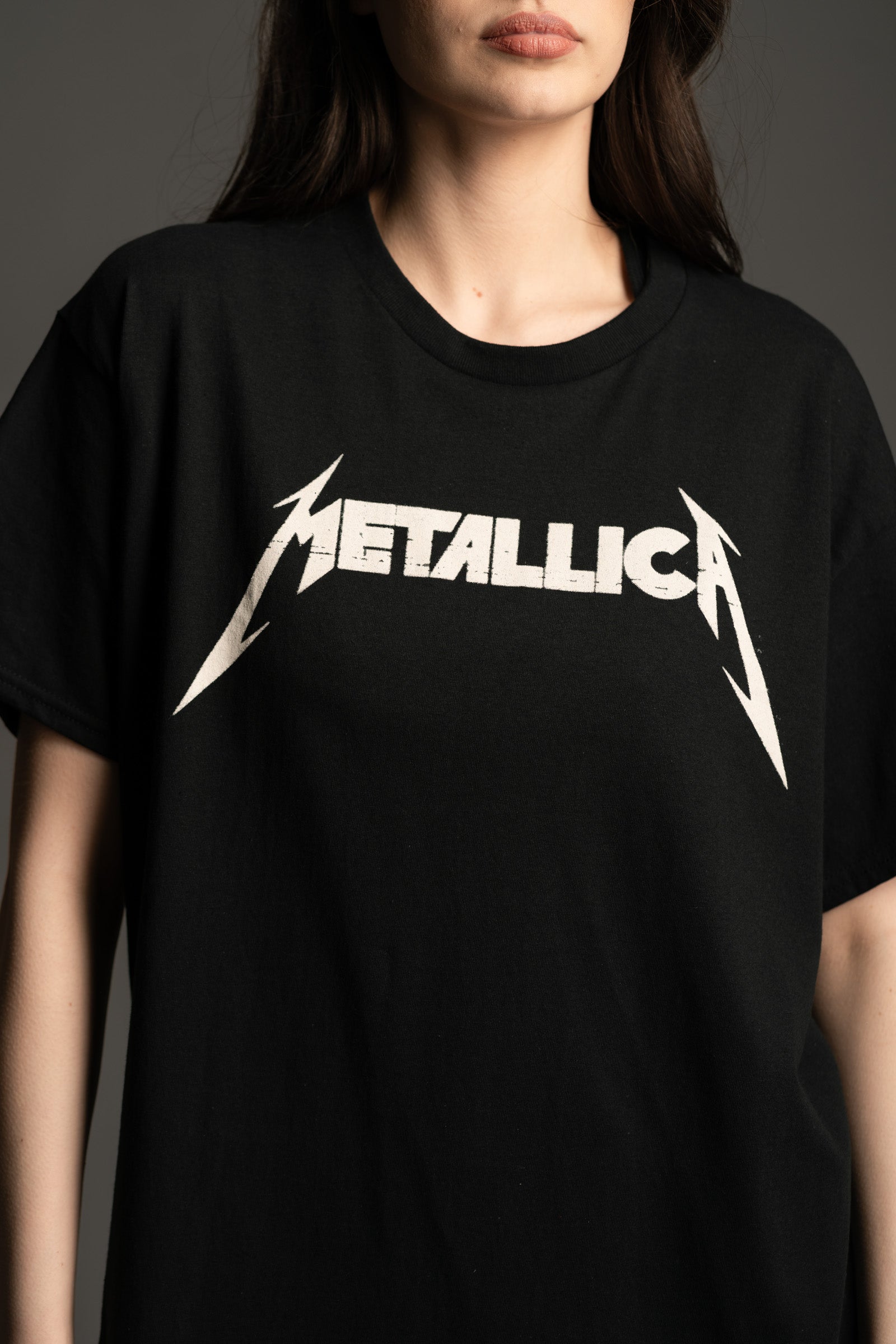 Close up of Little Lies oversized Metallica Master Of Puppets graphic T‑shirt with bold white logo on the front.