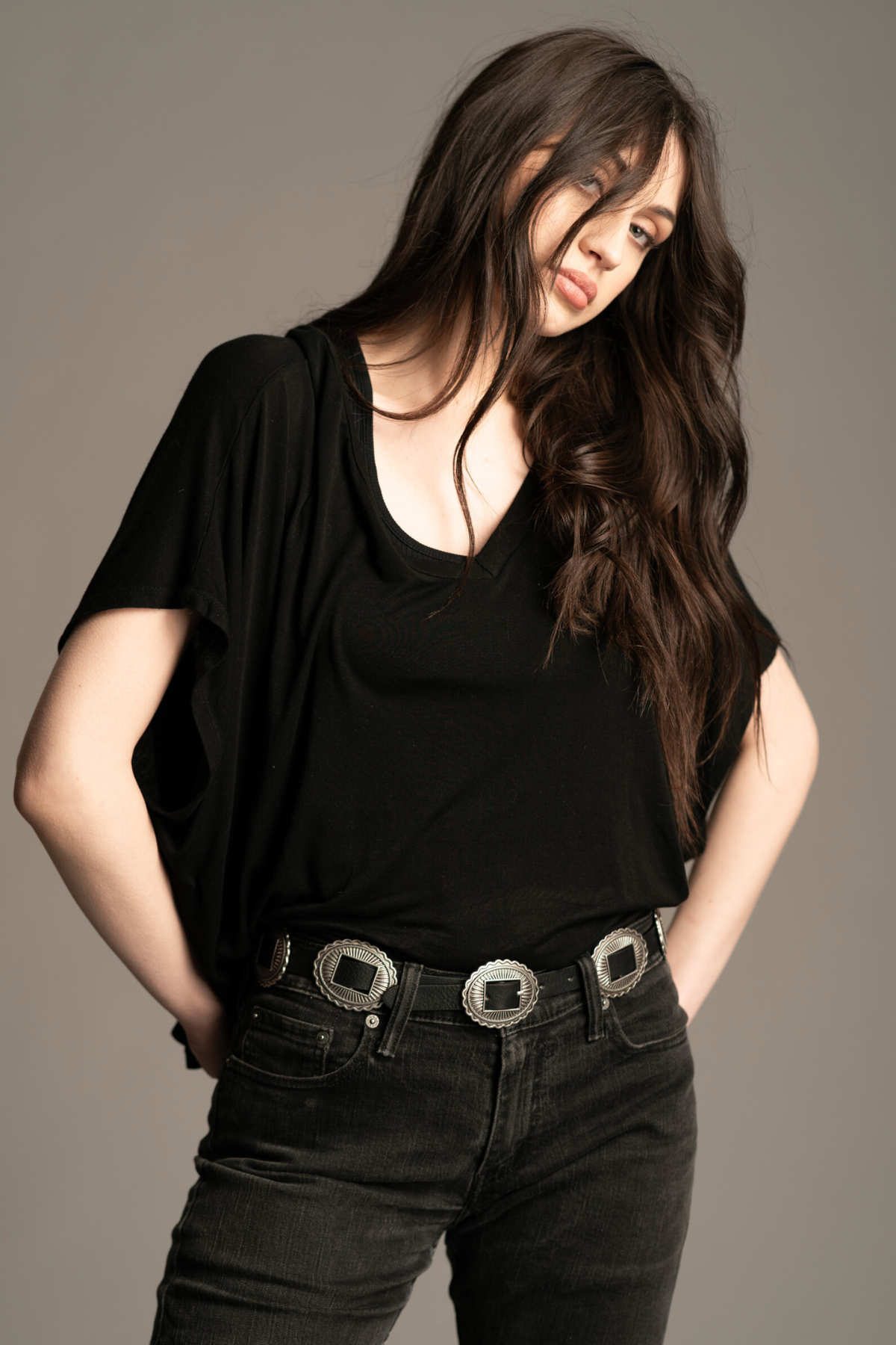 Model wearing the Morrison black leather concho western belt, with black top and jeans. A western style staple!