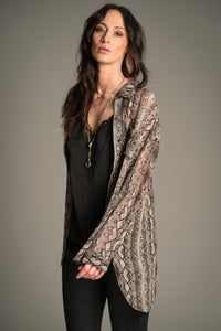 Victoria wears Little Lies Mosshart Snake Chiffon Shirt in sheer snake print, front angle showing lightweight longline fit worn open over a black satin cami.