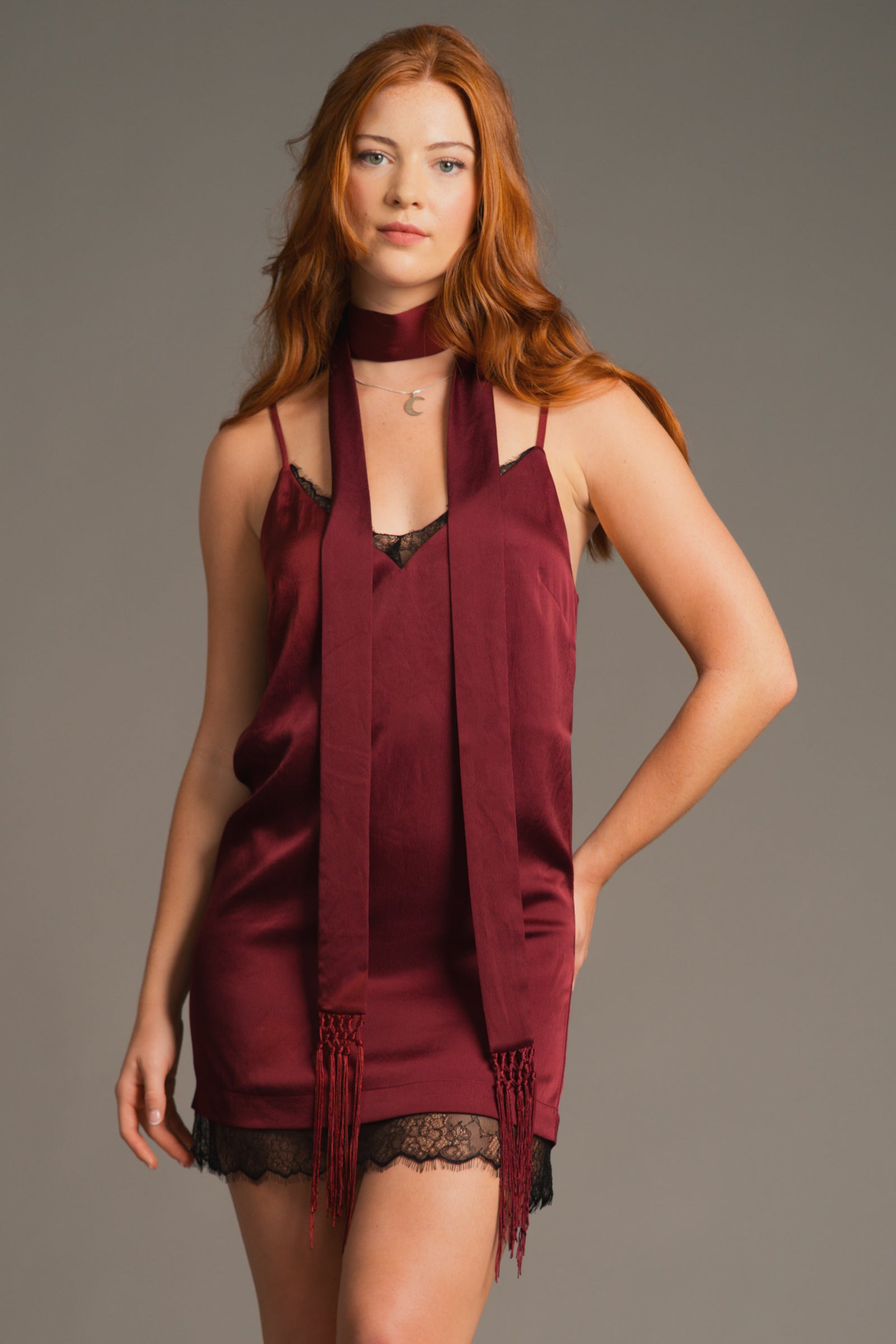 Anna posing in plum Nightbird Satin mini dress with lace trim, Plum skinny scarf co-ord. Boho autumn vibes.