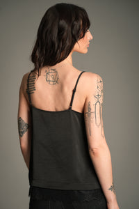 Victoria wears Little Lies Nightbird Lace Trim Cami Top in black, back view showing adjustable straps and lace‑trim hem.