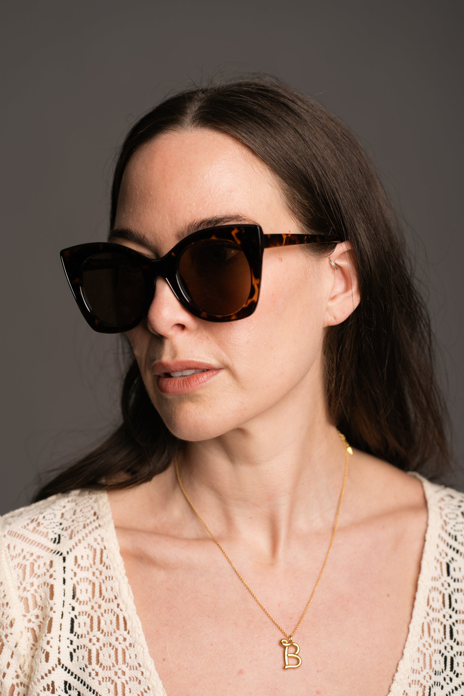 Suki Tortoiseshell Cat Eye Shades being worn by a brunette model wearing the Goldie Natural Crochet Dress
