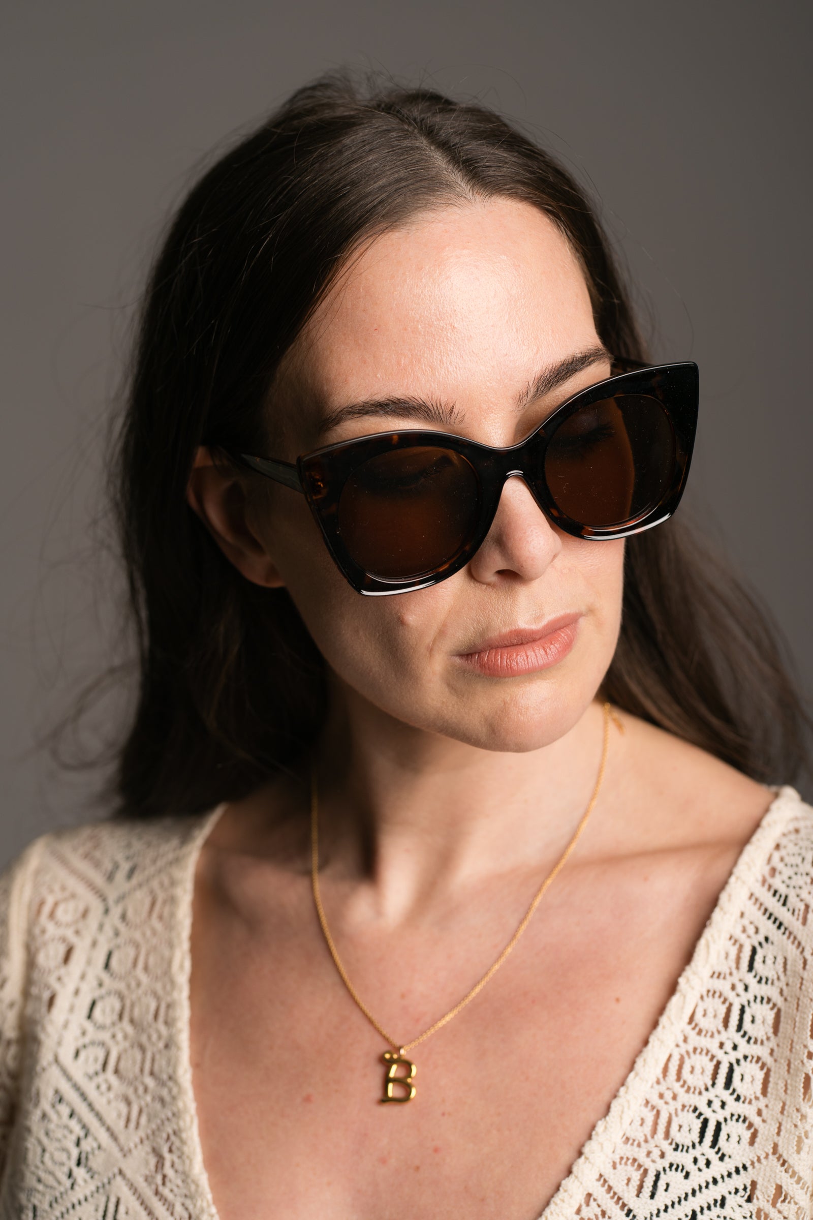 Suki Tortoiseshell Cat Eye Shades being worn by a brunette model wearing the Goldie Natural Crochet Dress