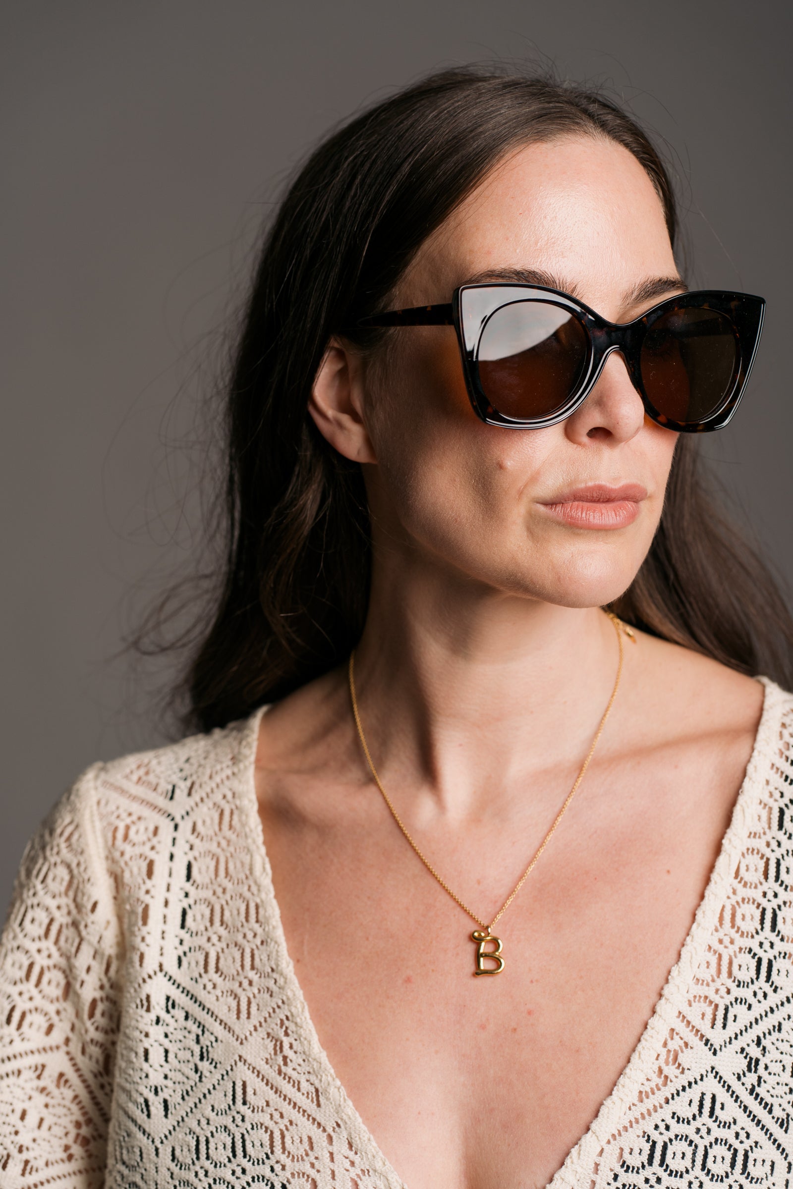 Suki Tortoiseshell Cat Eye Shades being worn by a brunette model wearing the Goldie Natural Crochet Dress