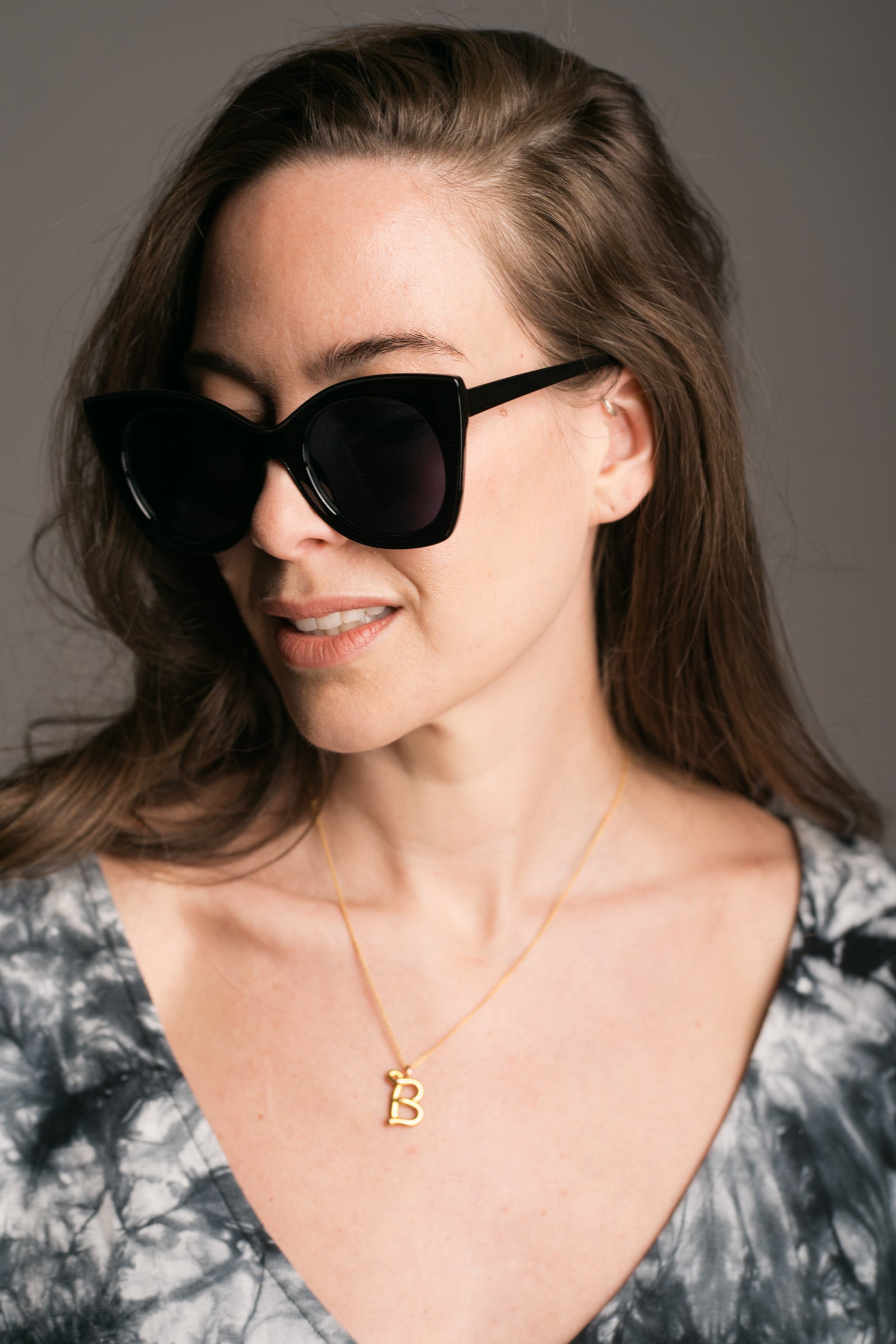 Suki Black Cat Eye Shades worn by brunette model wearing the Nevermind Tie Dye Midi Dress