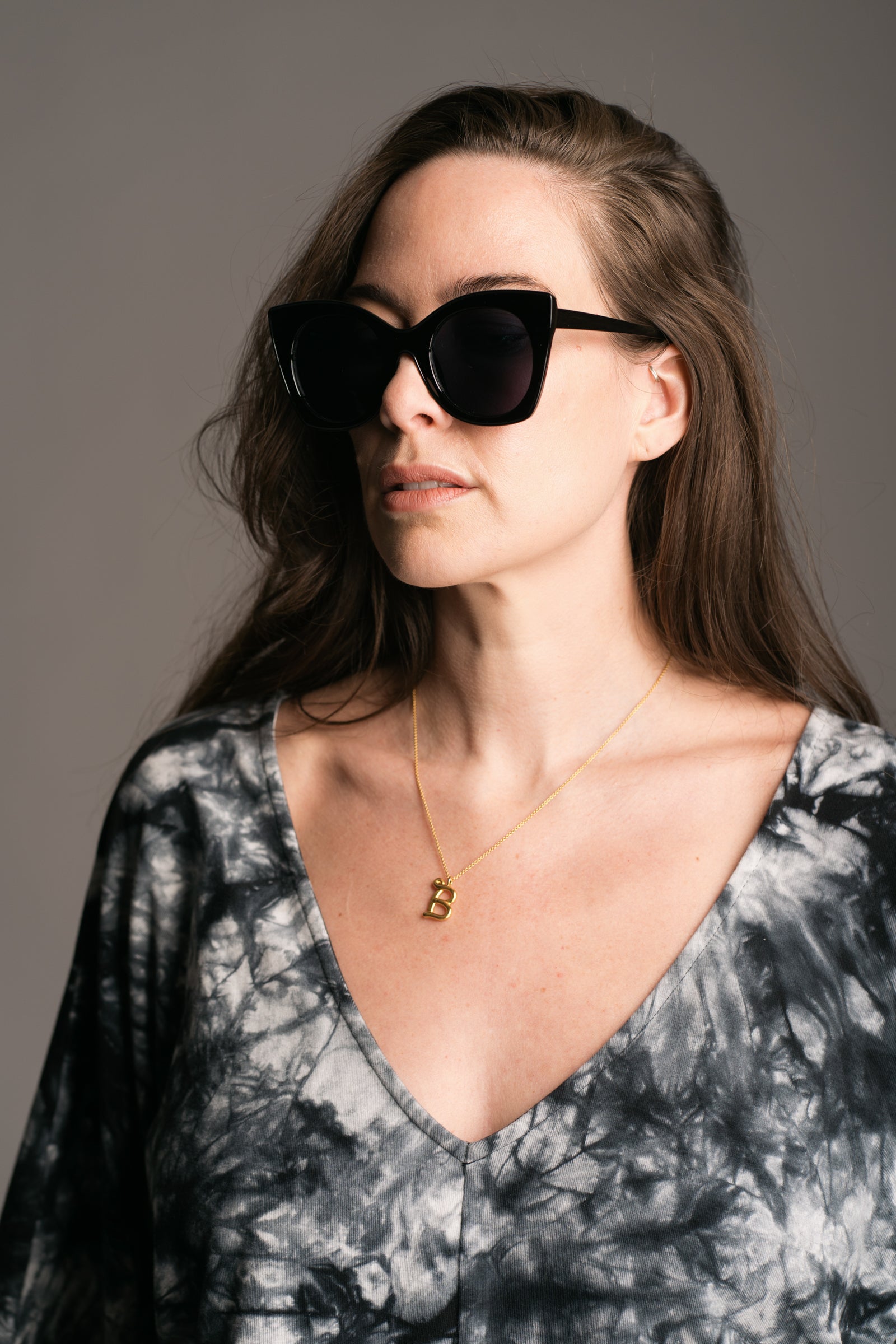 Suki Black Cat Eye Shades worn by brunette model wearing the Nevermind Tie Dye Midi Dress