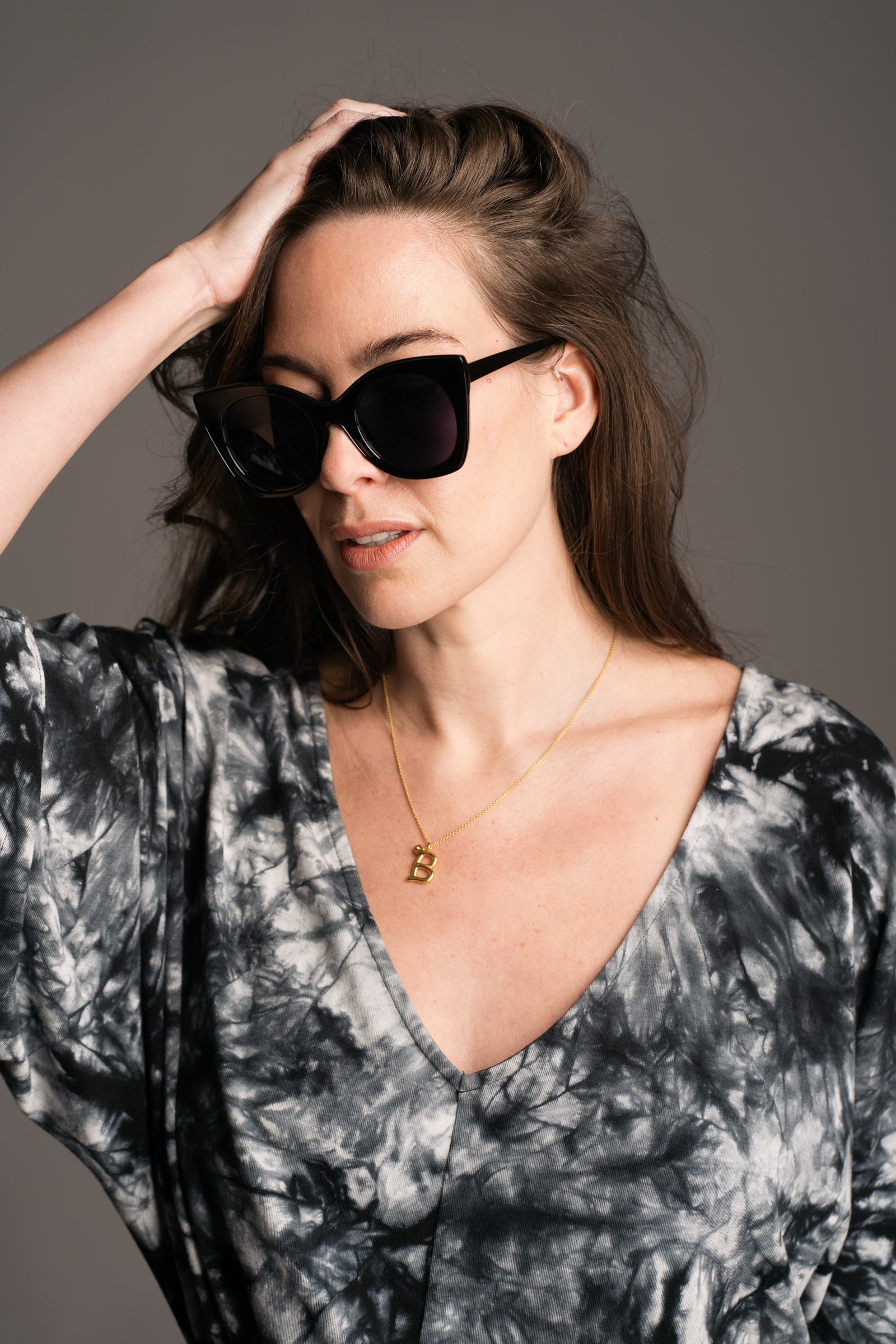 Suki Black Cat Eye Shades worn by brunette model wearing the Nevermind Tie Dye Midi Dress