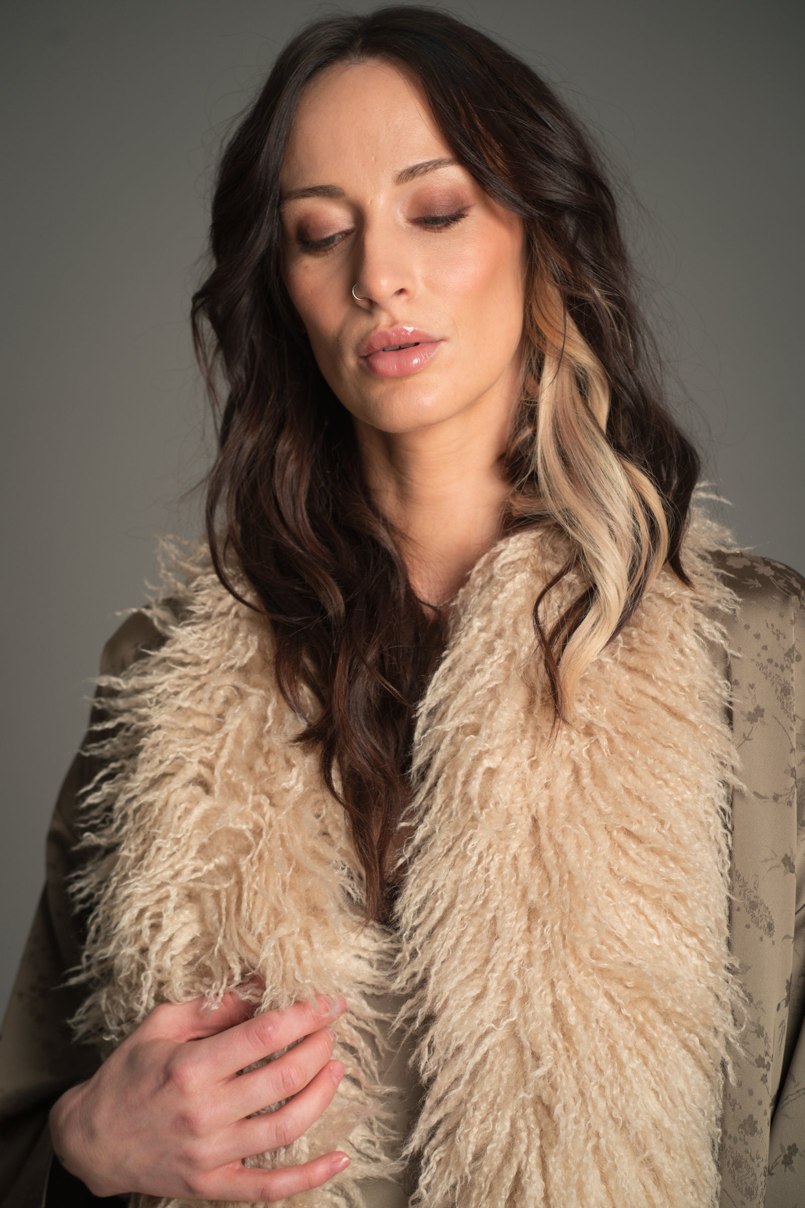 Little Lies Penny Lane faux Mongolian fur scarf in soft beige styled on model.