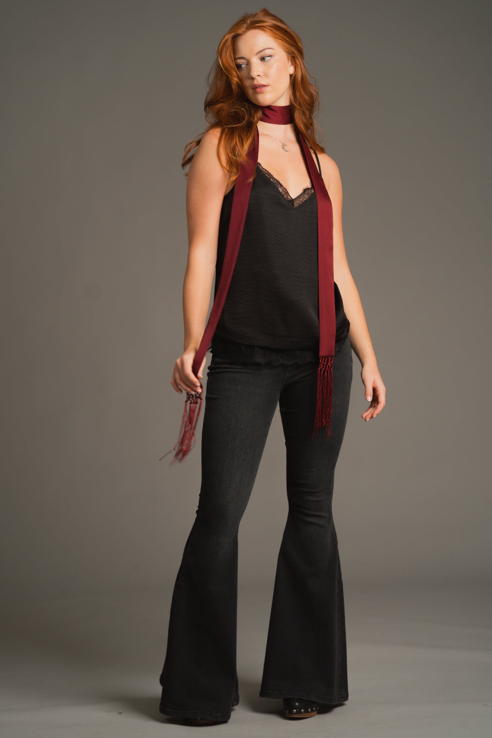 Plum hammered satin skinny scarf worn loosely over rocker-inspired outfit with red hair. Power Stance!