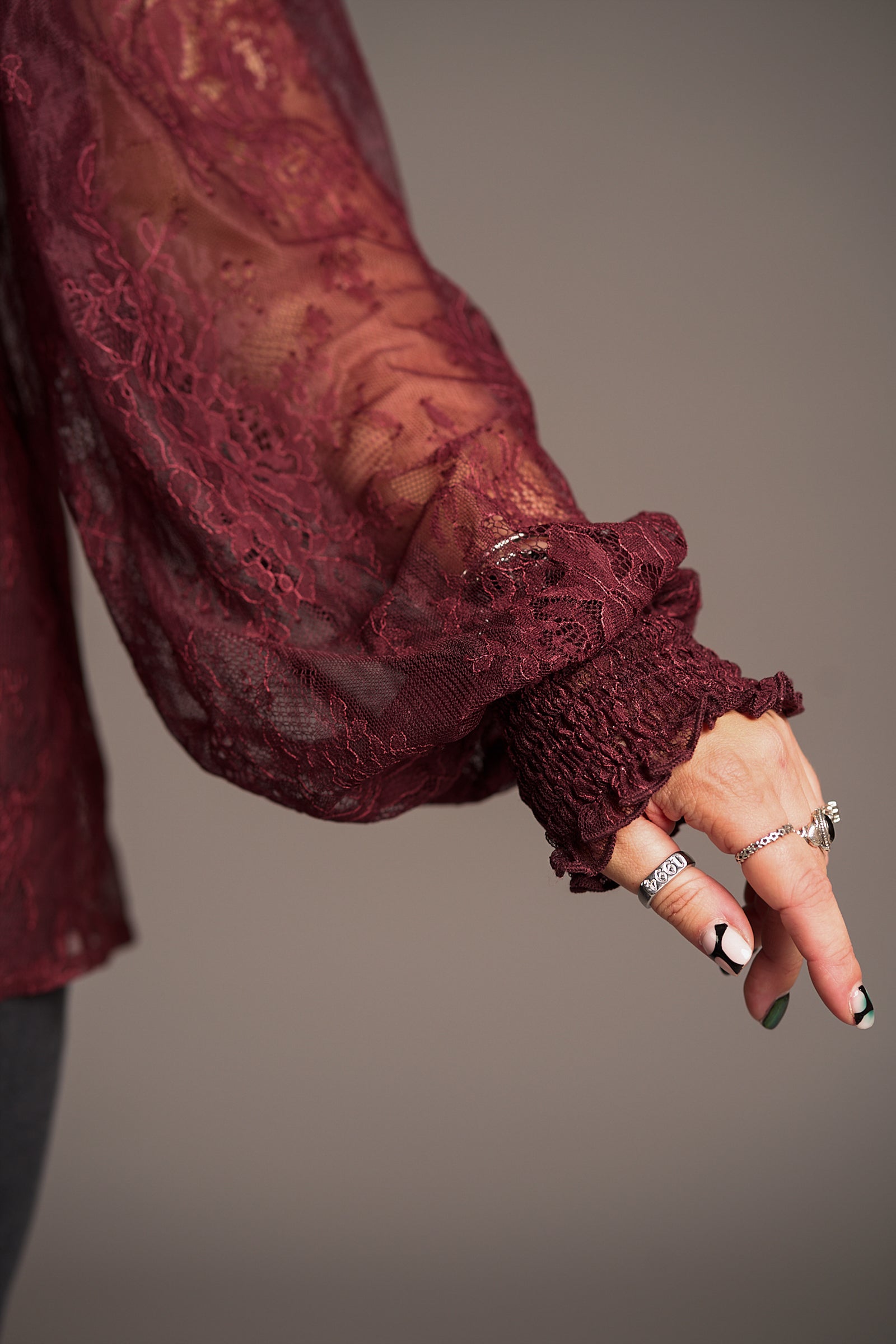 Close up of Rhiannon Burgundy Lace Smock Top sleeve with floral pattern detail and shirred cuff
