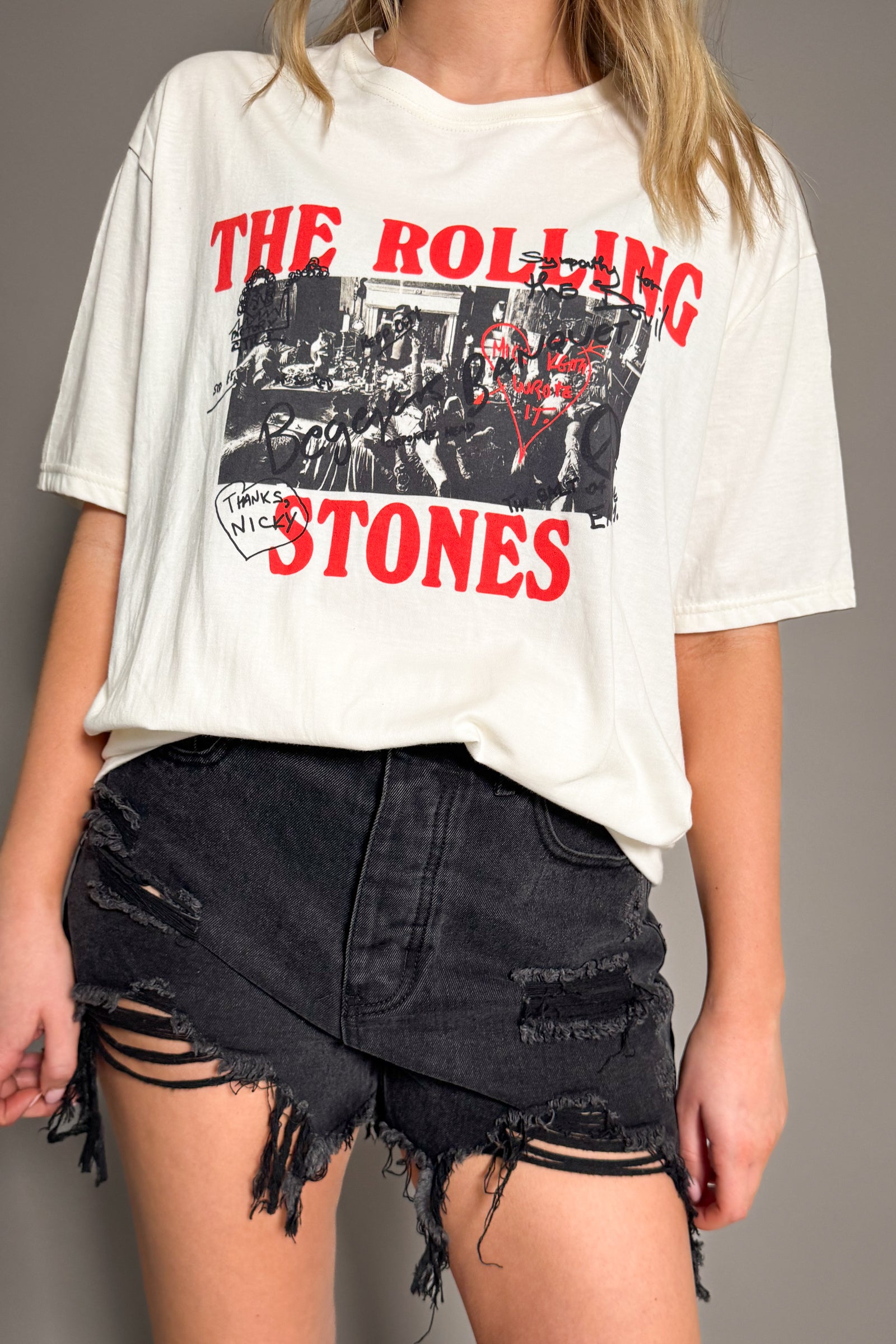 Full length view of Rolling Stones Graffiti band tee in off-white showing relaxed oversized fit
