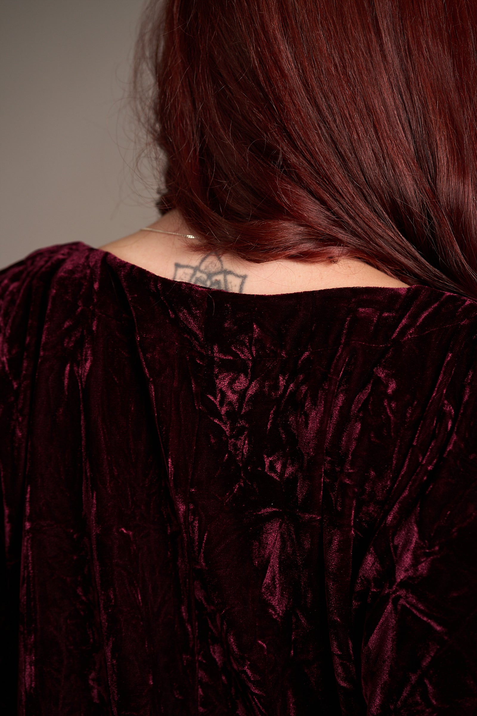 Close up of the back of the Rumours Merlot Velvet Midi Dress showcasing the rich burgundy material