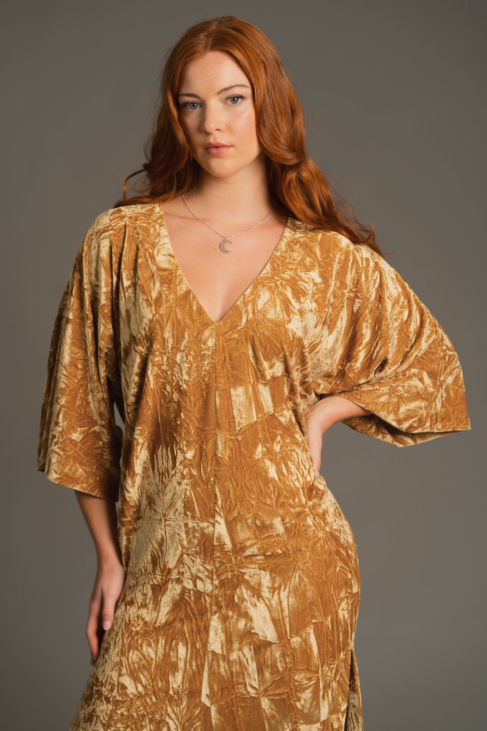 Anna posing with arm outstretched, showcasing V neckline and kimono-inspired sleeve