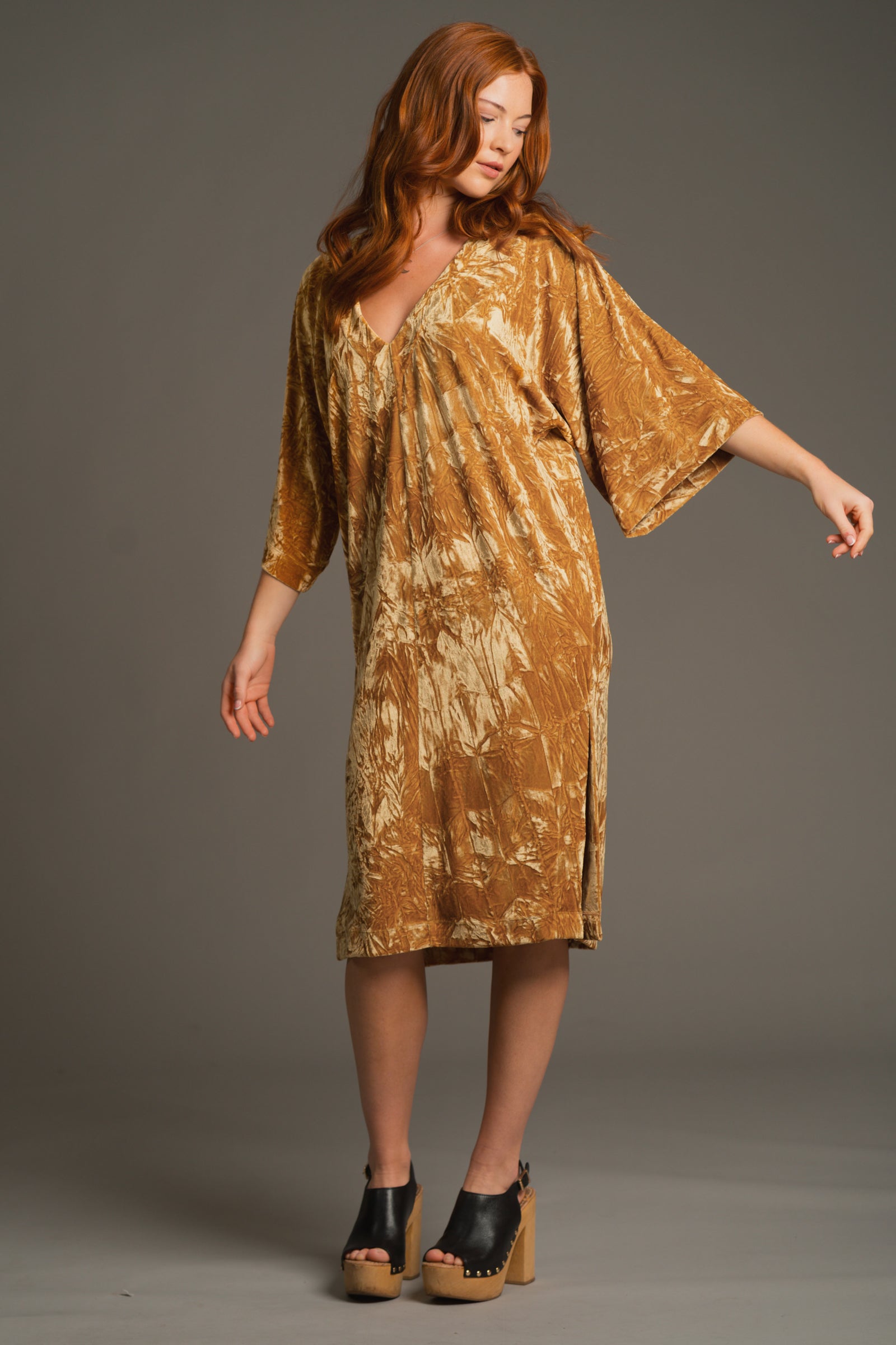 Anna posing with arm outstretched, showcasing V neckline and kimono-inspired sleeve