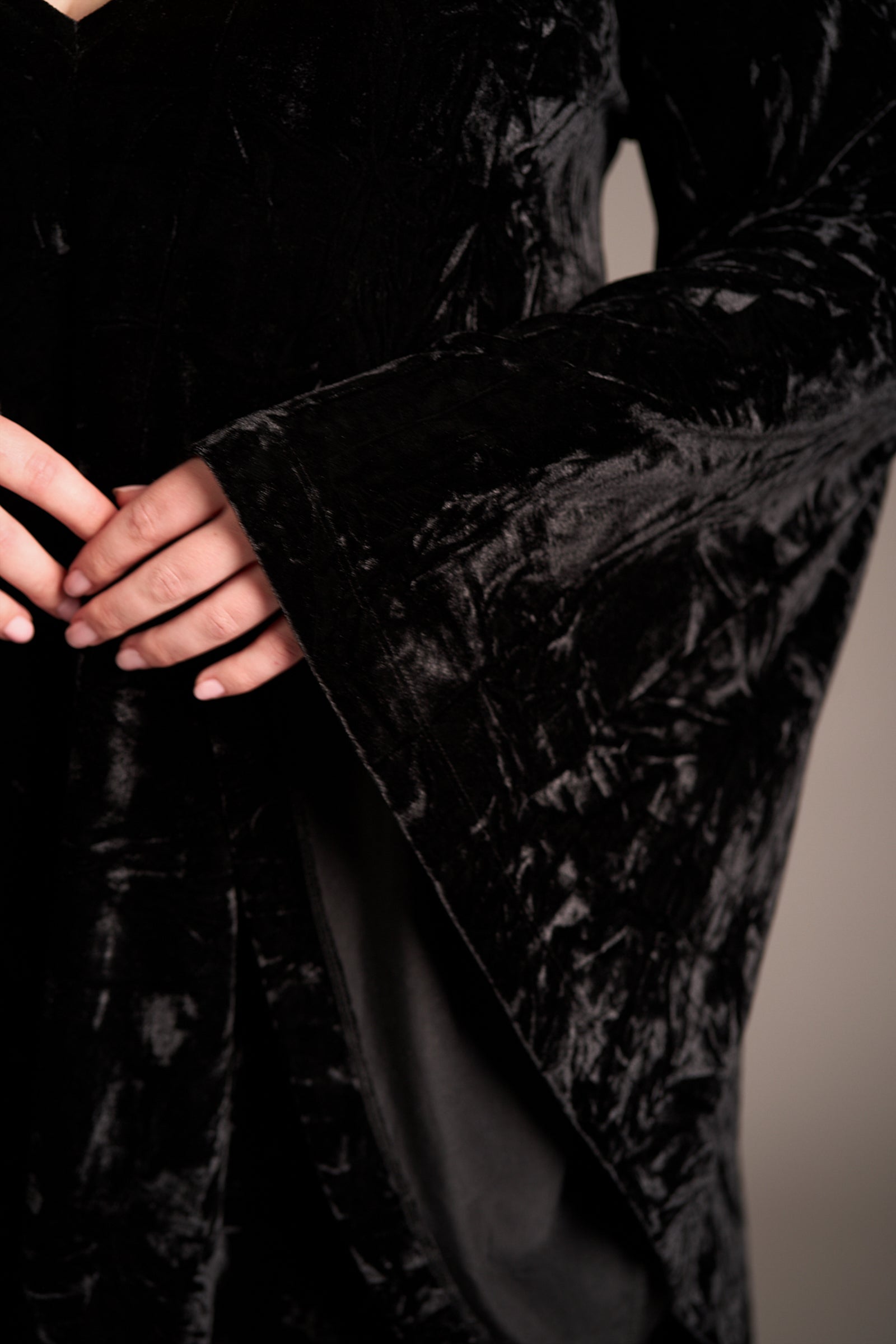 Close up showcasing the Sara Black Velvet Mini Dress with dramatic wide sleeve and rich textured fabric