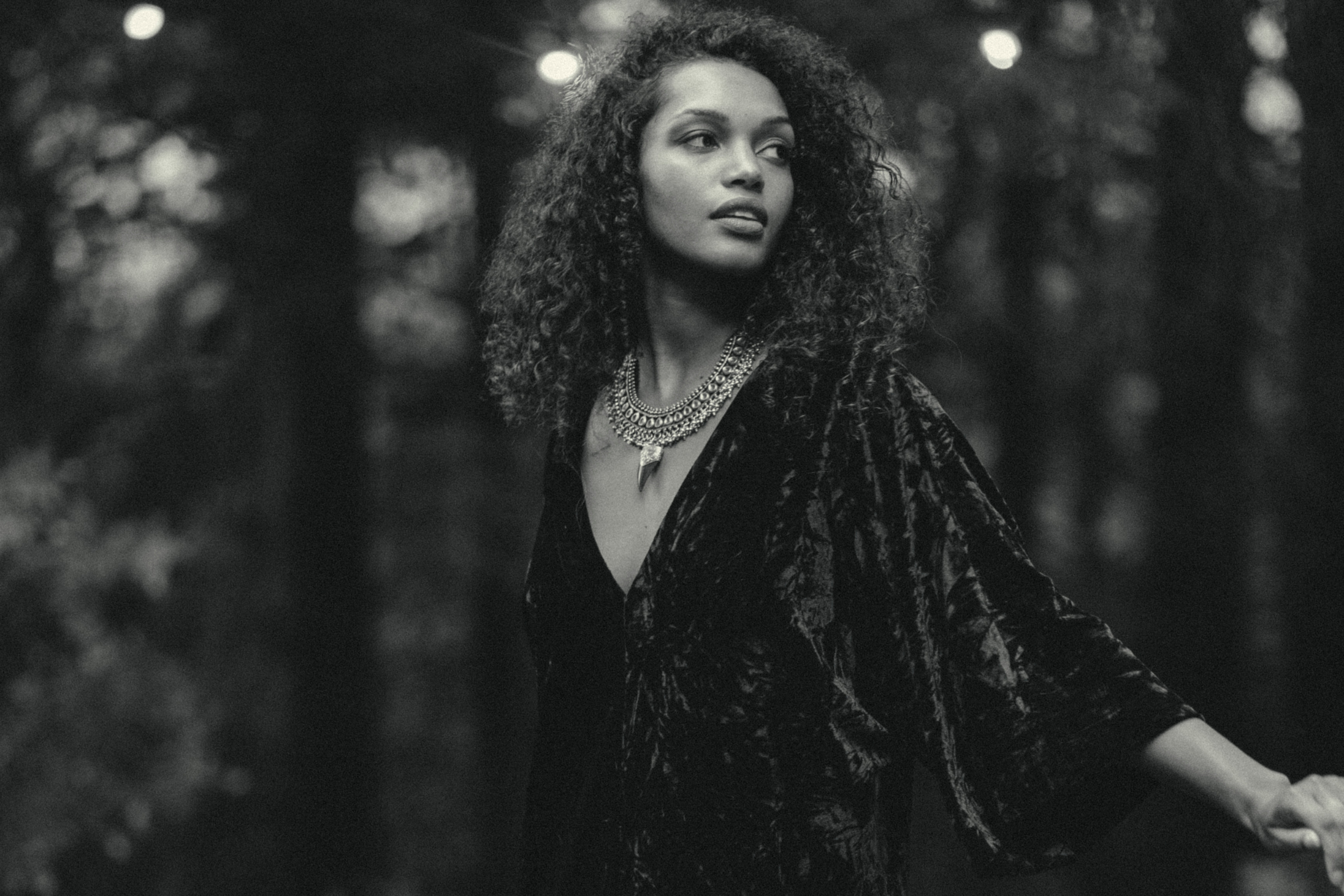 Model in the forest wearing Little Lies Seven Wonders Collection Dress