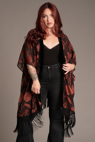 Taylor wears Venus Fringed Kimono with black sheer fabric, red floral print, and fringe hem. Stevie Nicks inspired styling studio