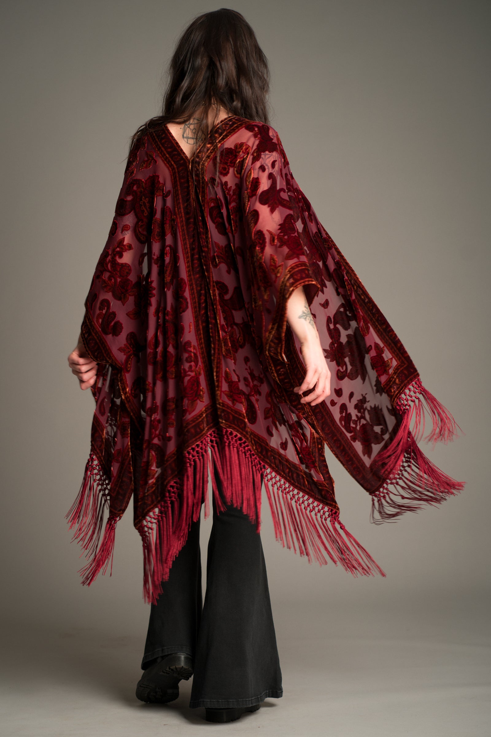 Little Lies Stevie Plum Paisley Devore Kimono in rich plum with velvet paisley pattern, long fringing and flowing open silhouette, back view.
