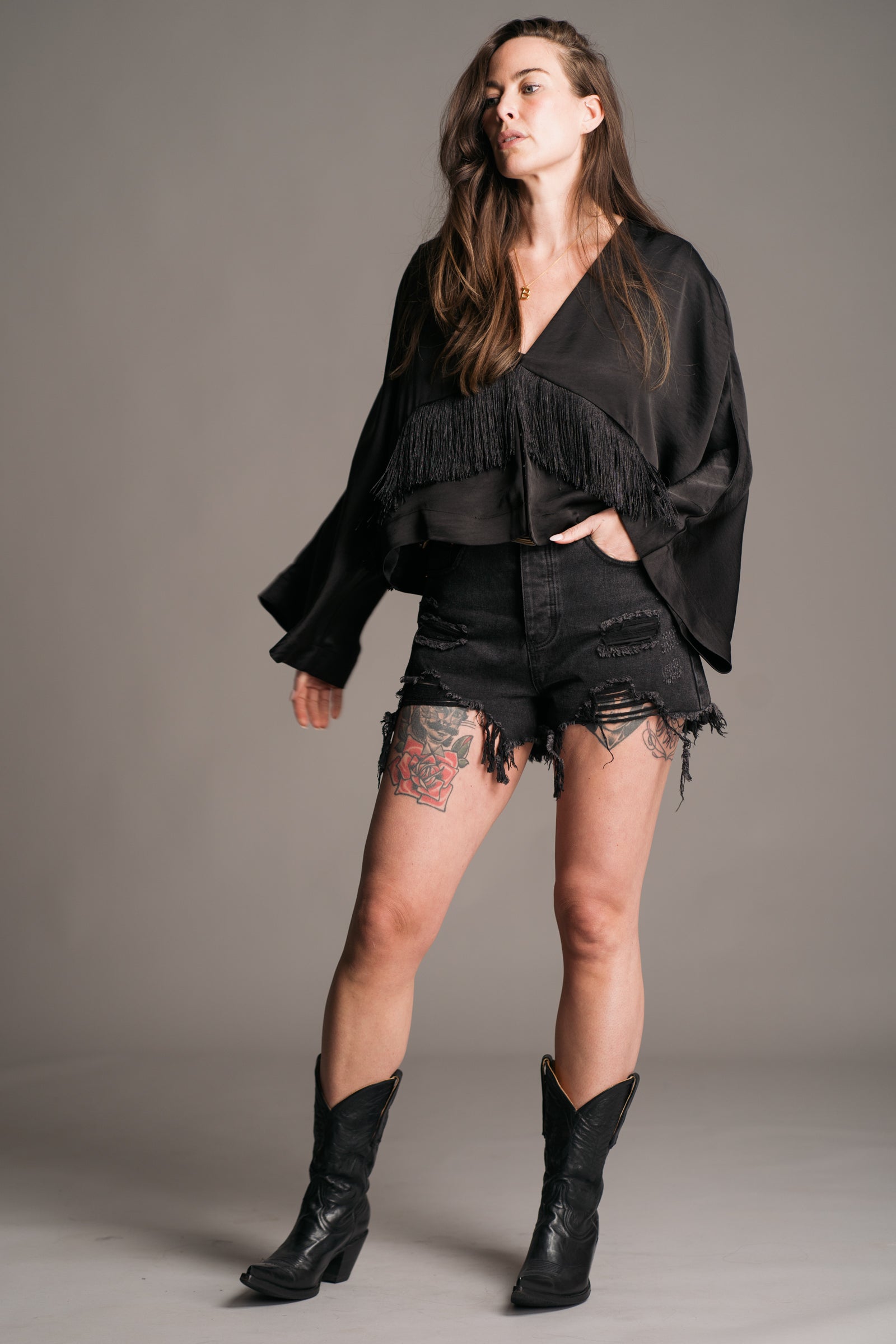 Back view of Little Lies Stevie Fringe Top showing batwing silhouette and flowing fringe trim