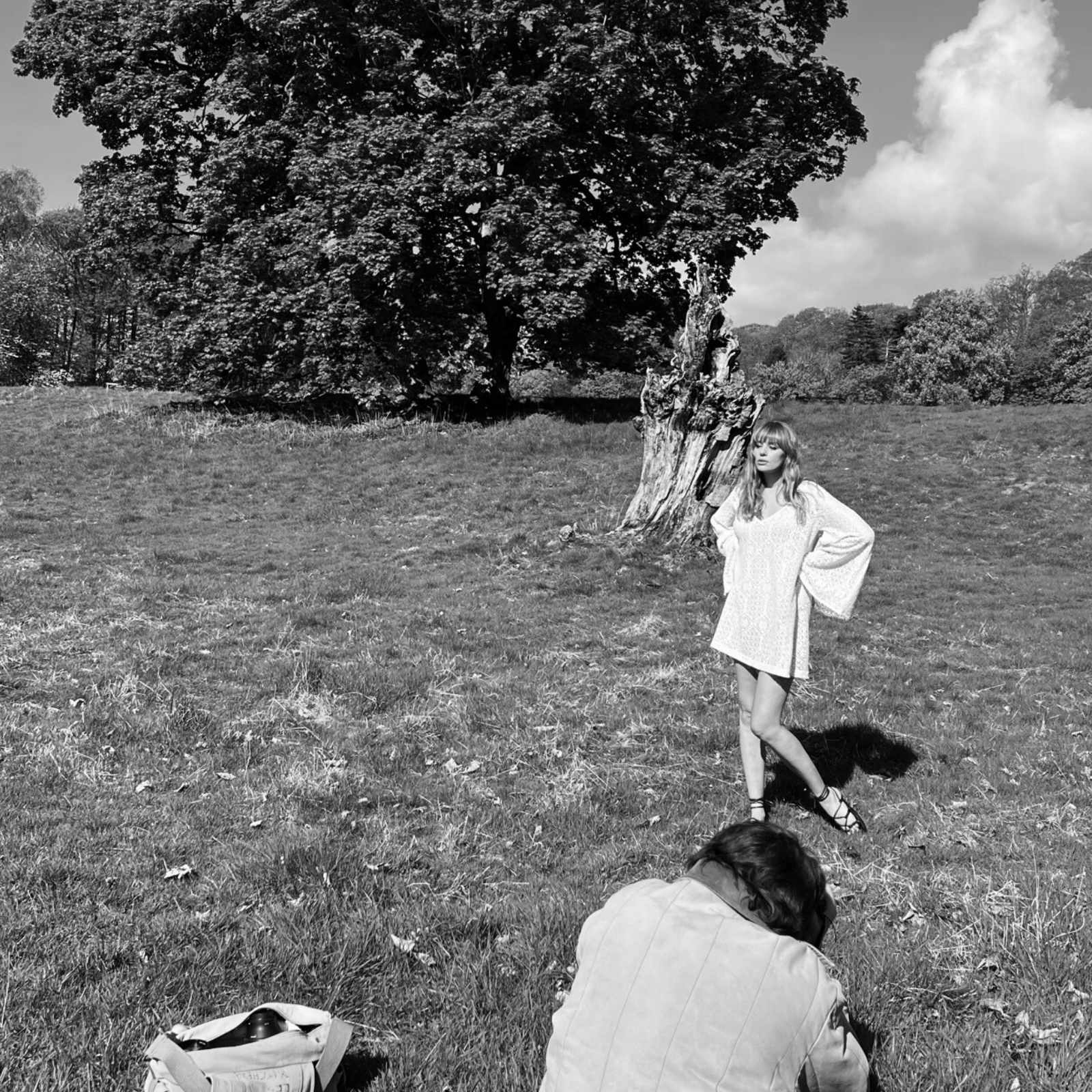 Model tinna being photographed by Tom Mitchell in festival field wearing the Bohemian Goldie Mini Dress