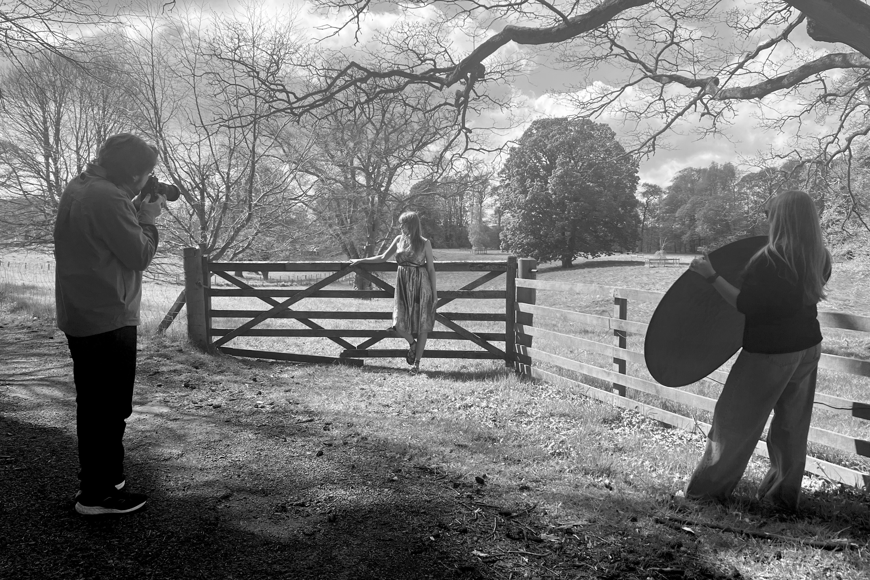 Model on set in festival field being photographed by Tom Mitchell and team.