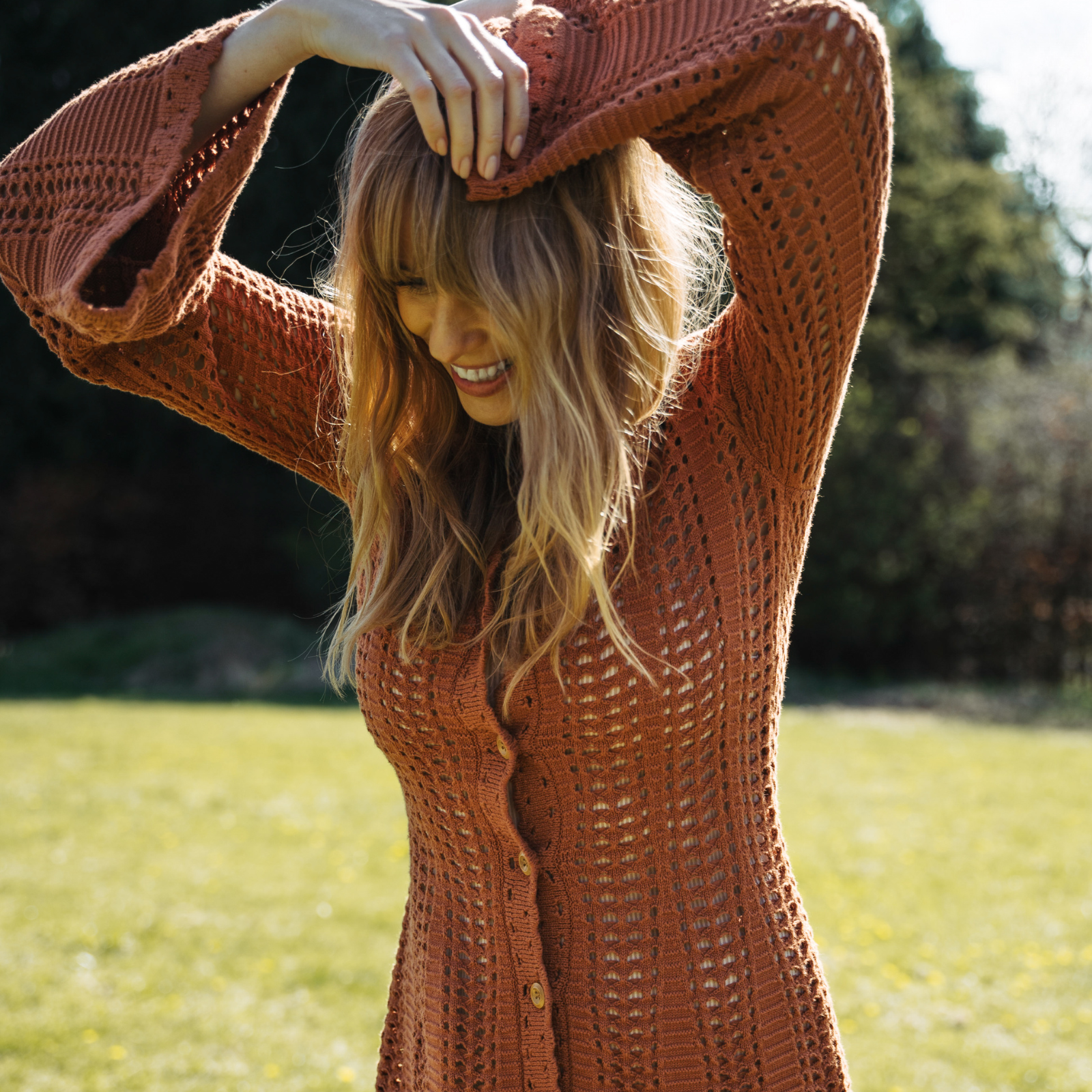 Model Tinna wearing the Marianne Rust Knitted Mini Dress, featuring flared sleeves, the perfect bohemian festival dress