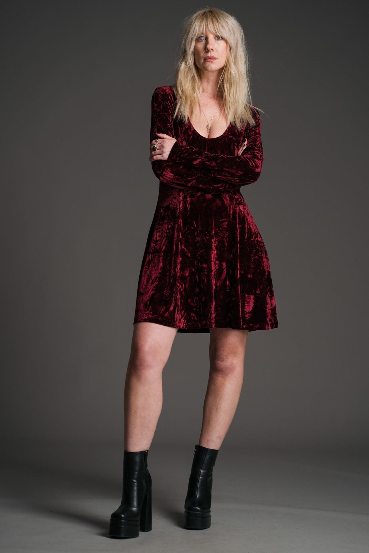 Sara wearing the Little Lies Sweet Jane Merlot crushed velvet long‑sleeve mini dress in a studio setting