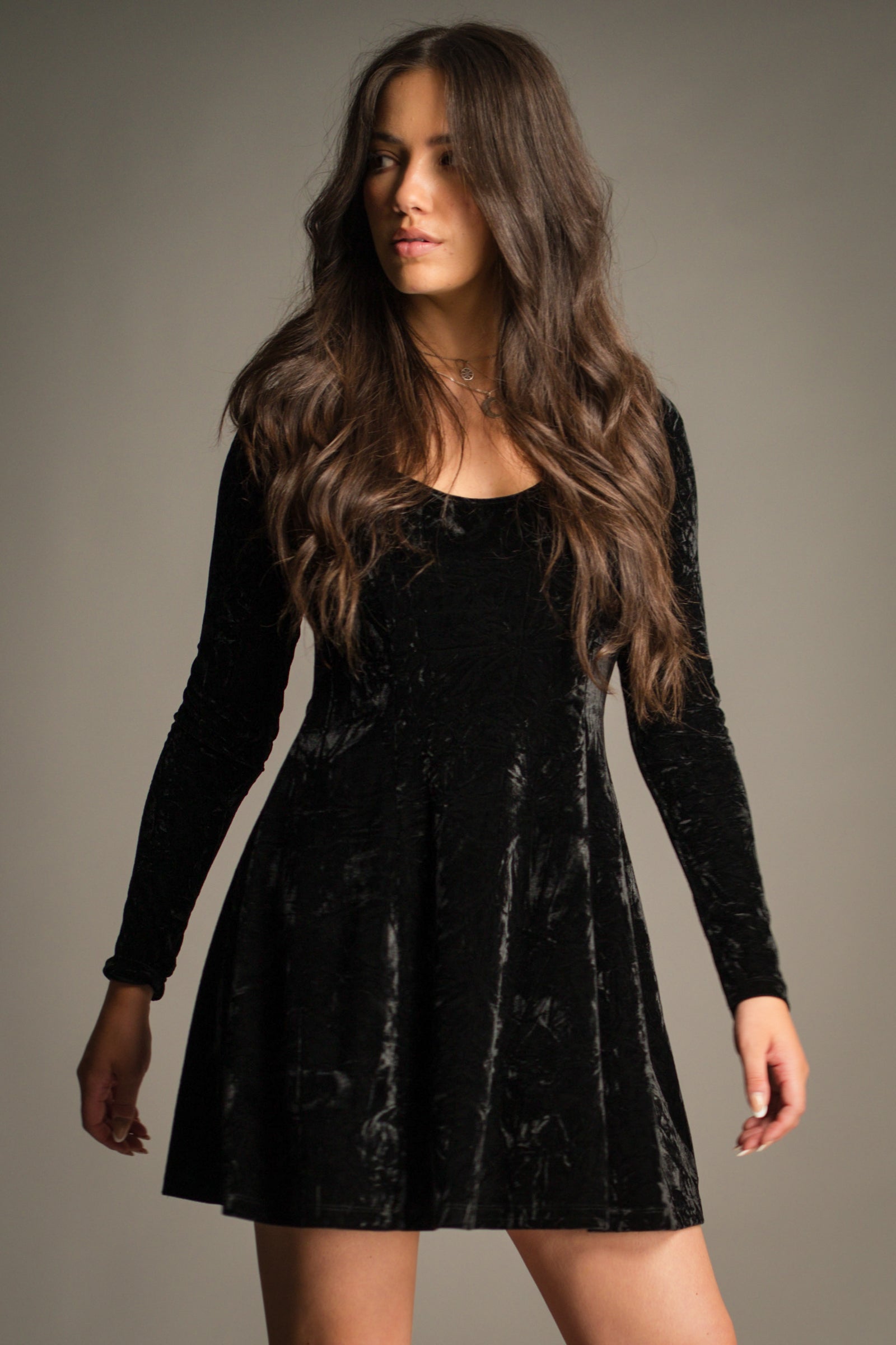 Close-up front view of the Sweet Jane Black Crushed Mini Dress featuring a scoop neckline, flattering waist seam and rich black crushed velvet finish