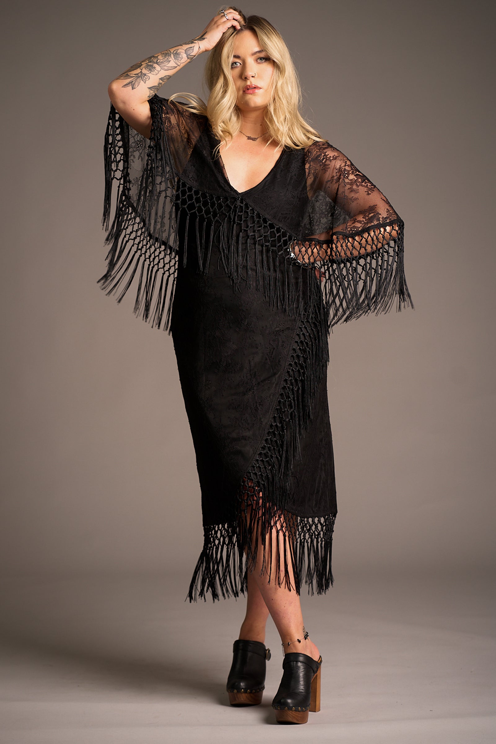Erin wears Tango in the Night cape lace midi dress with V-neckline and tassel hem. Stevie Nicks inspired styling studio