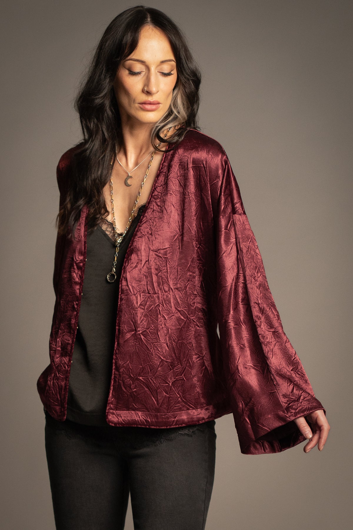 Celeste wine kimono top worn open featuring a deep V-neckline, velvet piping detail, relaxed fit and flowing kimono sleeves