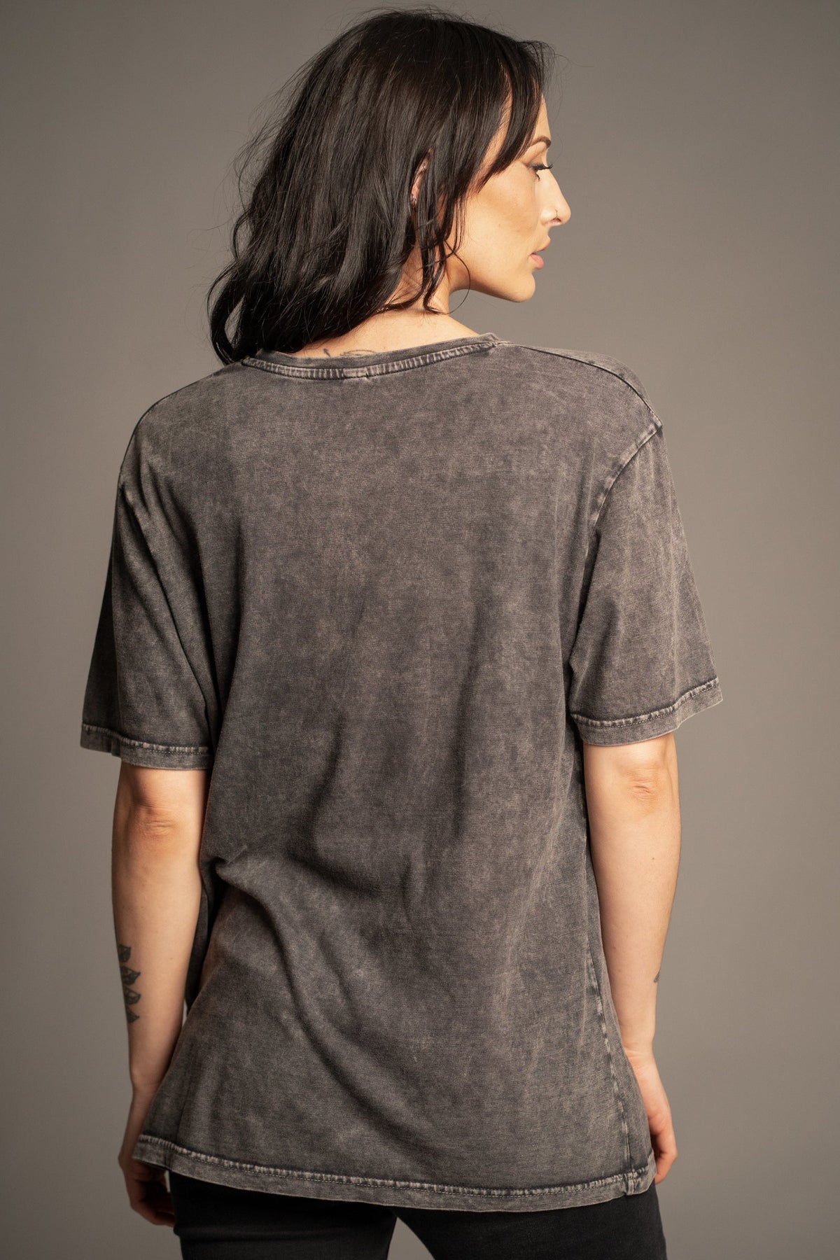 Back view of Victoria wearing the Depeche Mode charcoal vintage wash band T-shirt with Hendrix Denim Flares