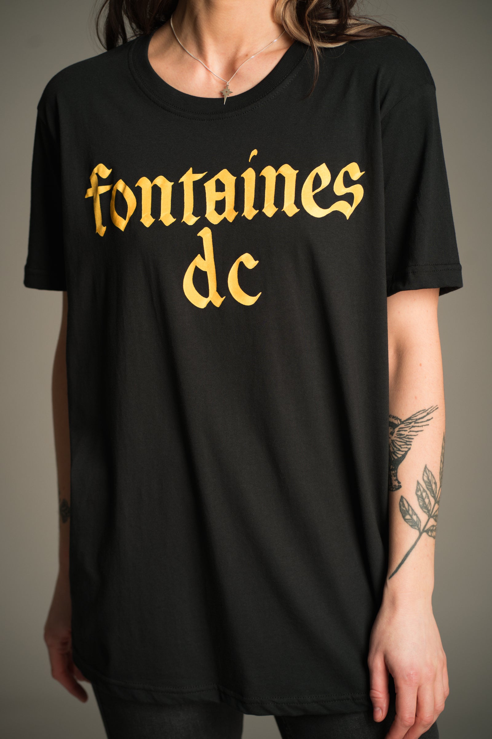 Fontaines D.C. gold gothic logo on black T-shirt