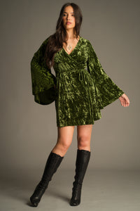 Front view of the Jaded Olive Crushed Velvet Wrap Mini Dress in rich mossy olive velvet. Styled with vintage YSL knee high boots.