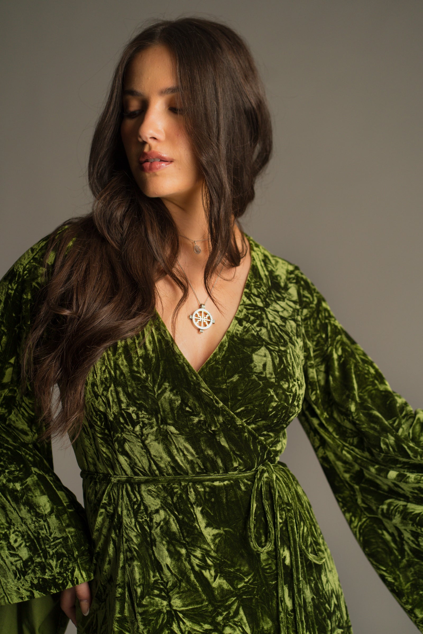 V-neck detail view of the Jaded Olive Crushed Velvet Wrap Mini Dress showing tie waist.