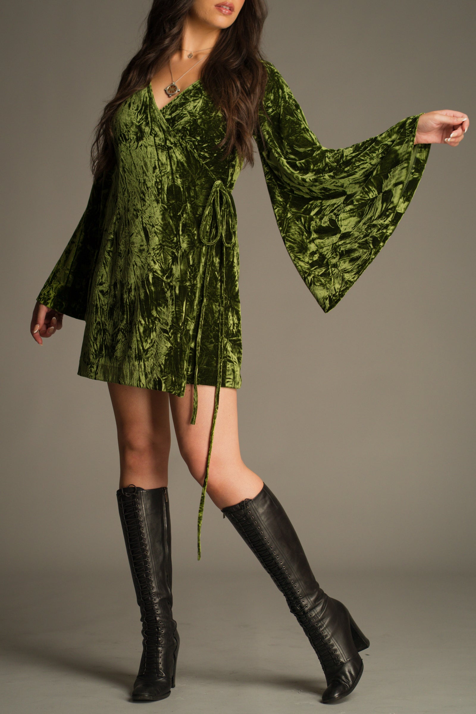 Front view of dramatic flared sleeve detail on the Jaded Olive Crushed Velvet Wrap Mini Dress.