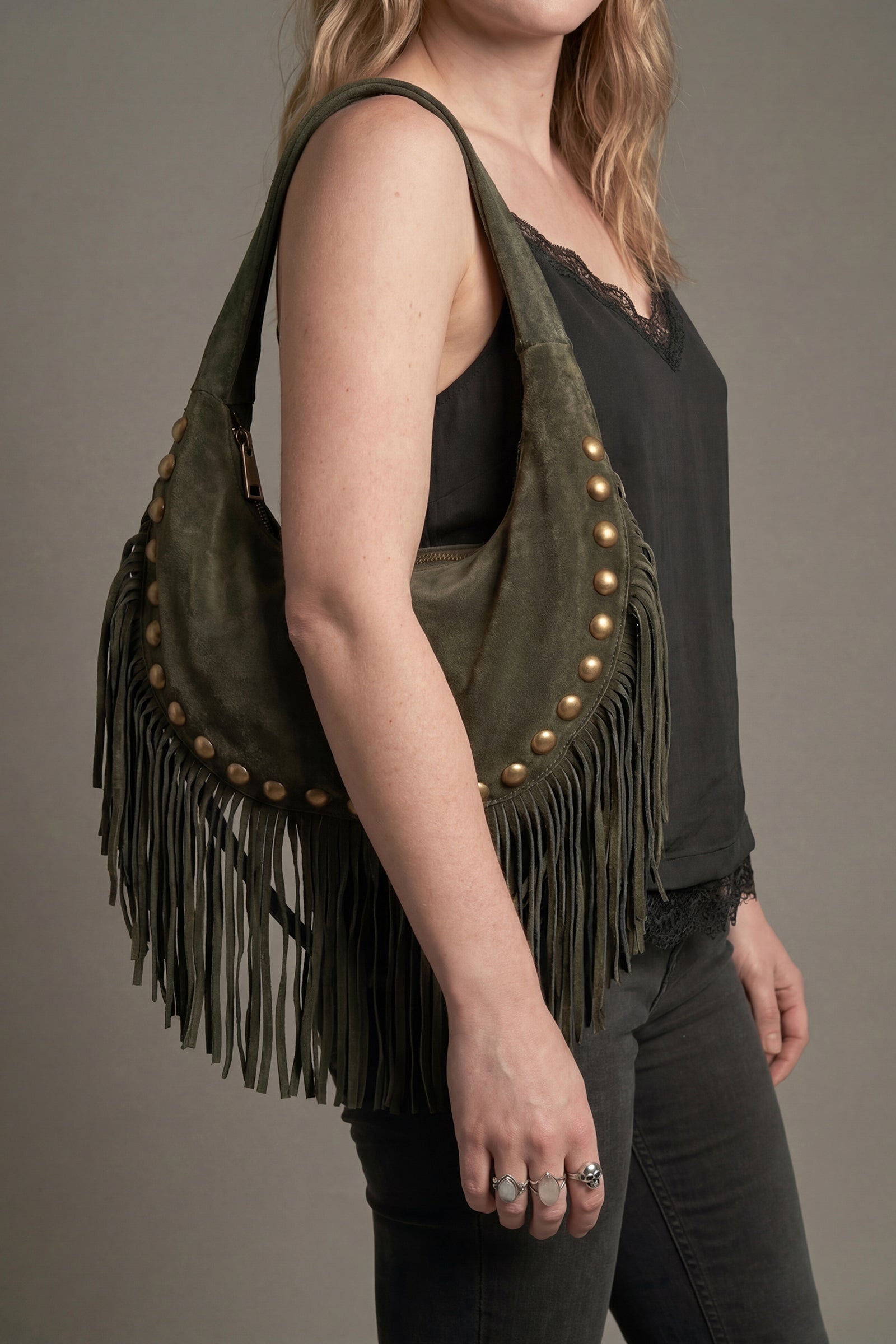 Kate Khaki suede studded fringe bag worn on shoulder styled with Hendrix Denim Flares