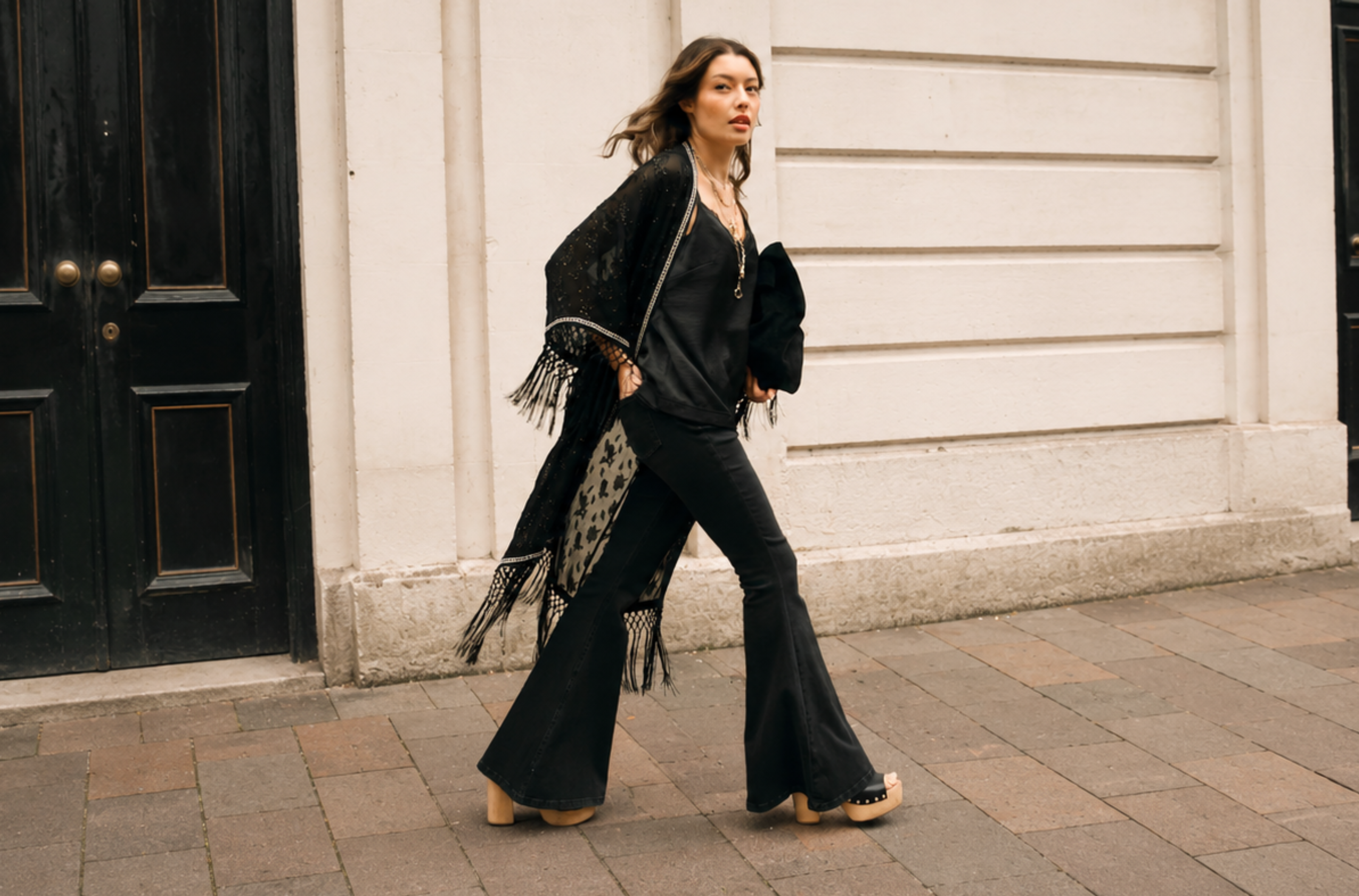Little Lies Electric Lady Studded Kimono in black metallic jacquard chiffon with fringe hem and studded trim worn open, street style.
