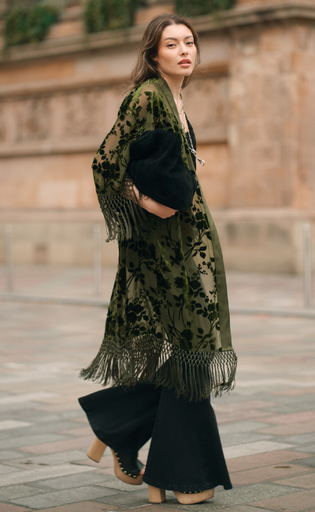 Dakota Olive Devore Kimono by Little Lies featuring velvet burnout detailing, fringe trim and a flowing bohemian silhouette styled with a suede bag and flared jeans