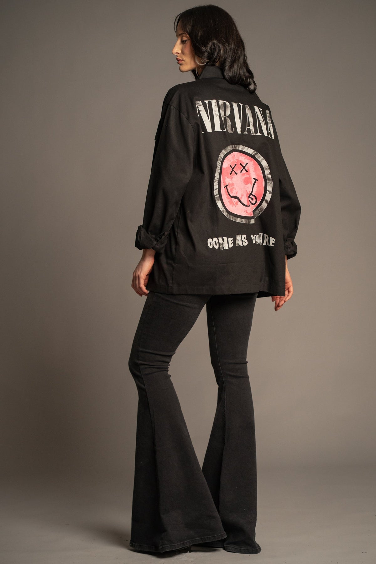 Victoria wearing the Nirvana Come As You Are black overshirt with pink smiley back graphic