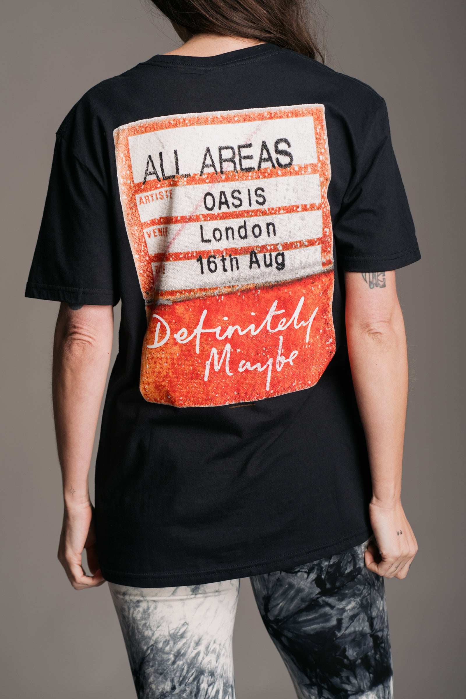 Full length back view of Oasis Access All Areas Band Tee styled with flares from Little Lies