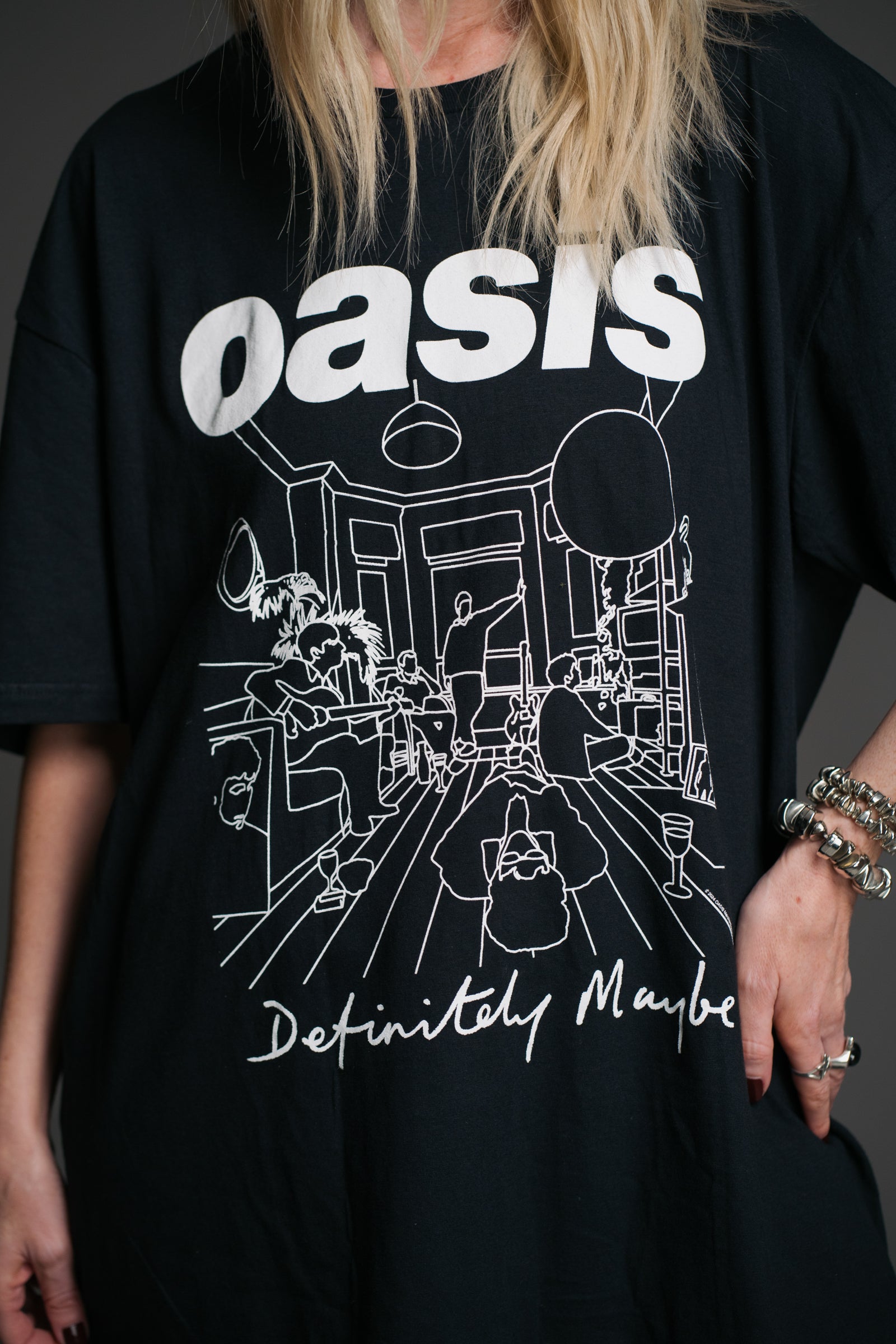 Unisex black Oasis Definitely Maybe graphic t‑shirt by Little Lies featuring bold white Oasis logo and illustrated album artwork detail