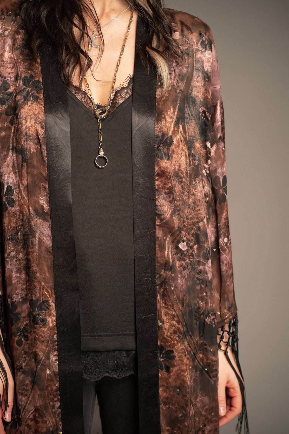 Close-up of Practical Magic kimono showcasing vintage-inspired floral print, sheer fabric and black satin trim