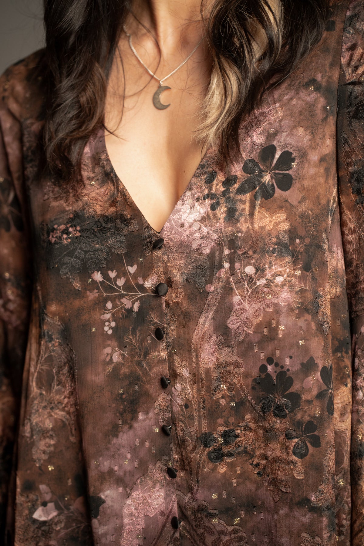 Practical Magic mini dress close-up featuring deep V-neckline, vintage floral print and button-front detailing