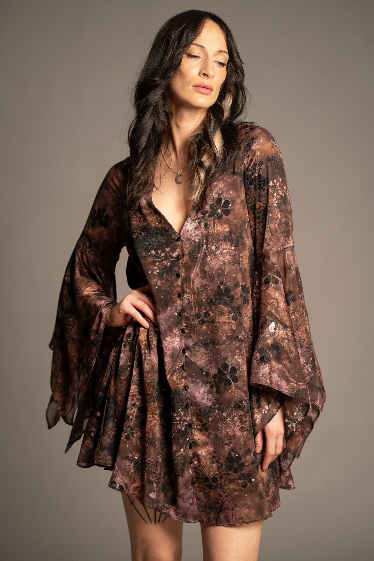 Practical Magic mini dress with vintage-inspired floral print, deep V-neckline and flowing hanky sleeves front view