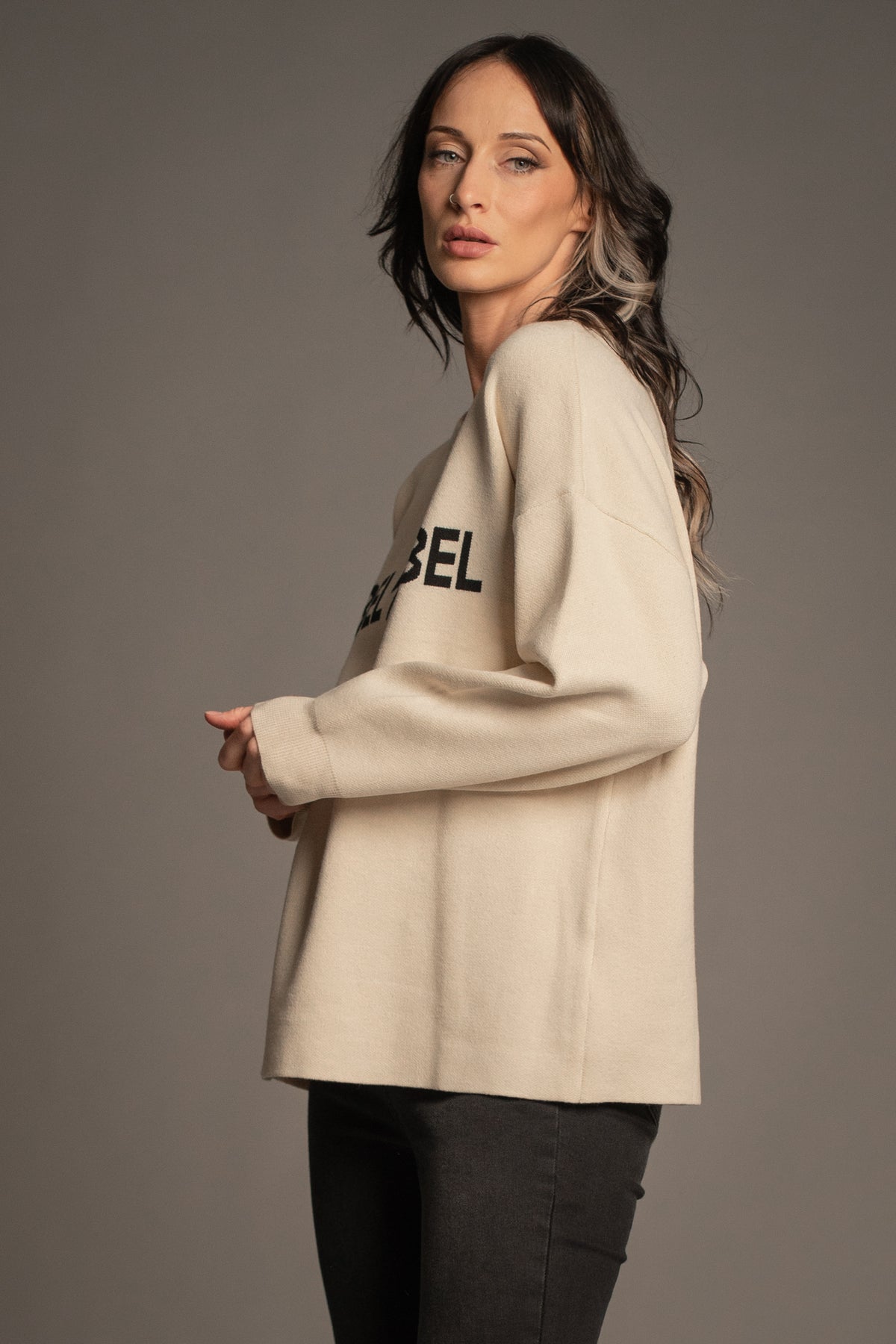 Victoria in the Rebel Rebel Cream Knit Jumper — side view showing relaxed oversized fit