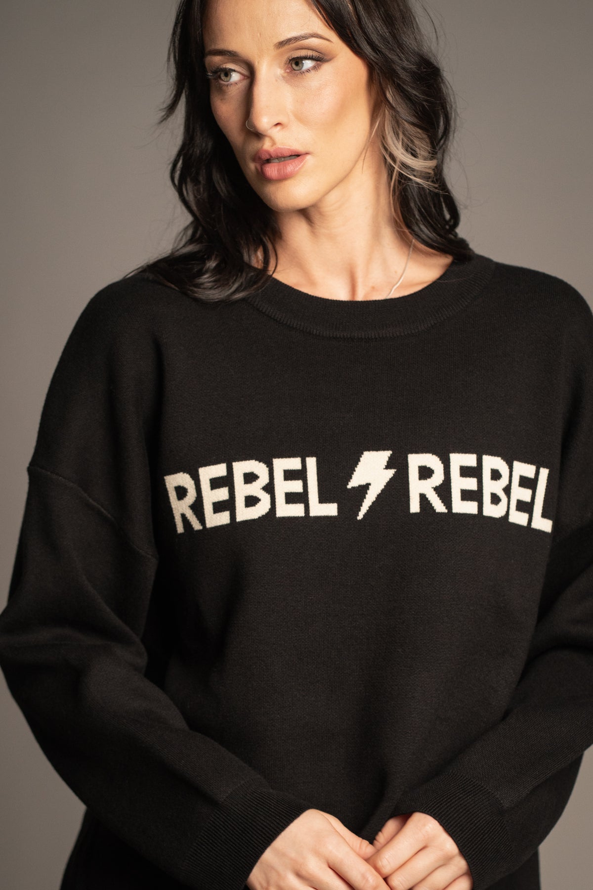Rebel Rebel Knit Jumper front view showing oversized fit and ivory graphic slogan