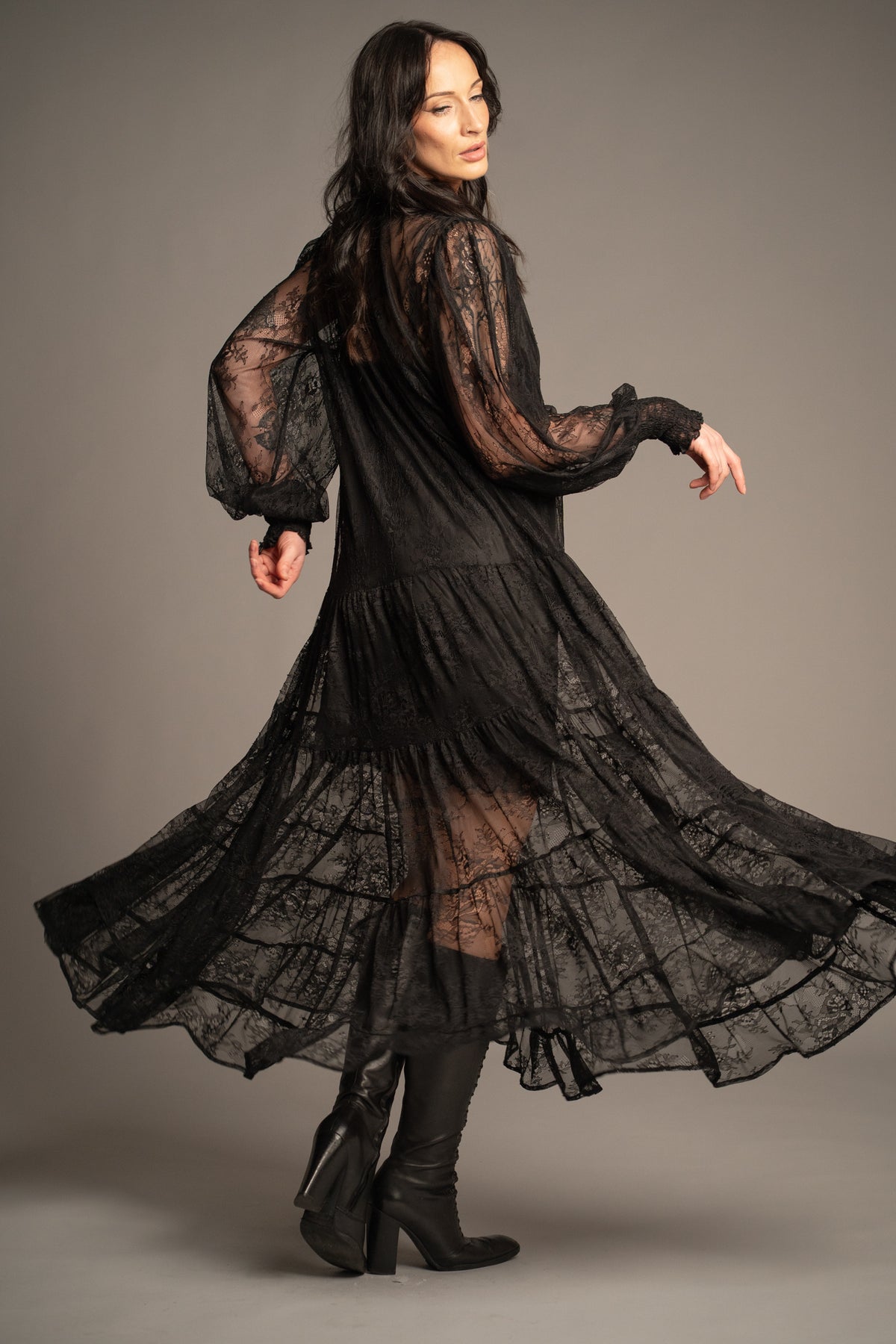 Rhiannon black lace maxi dress back view featuring sheer floral lace, tiered maxi silhouette and flowing hemline