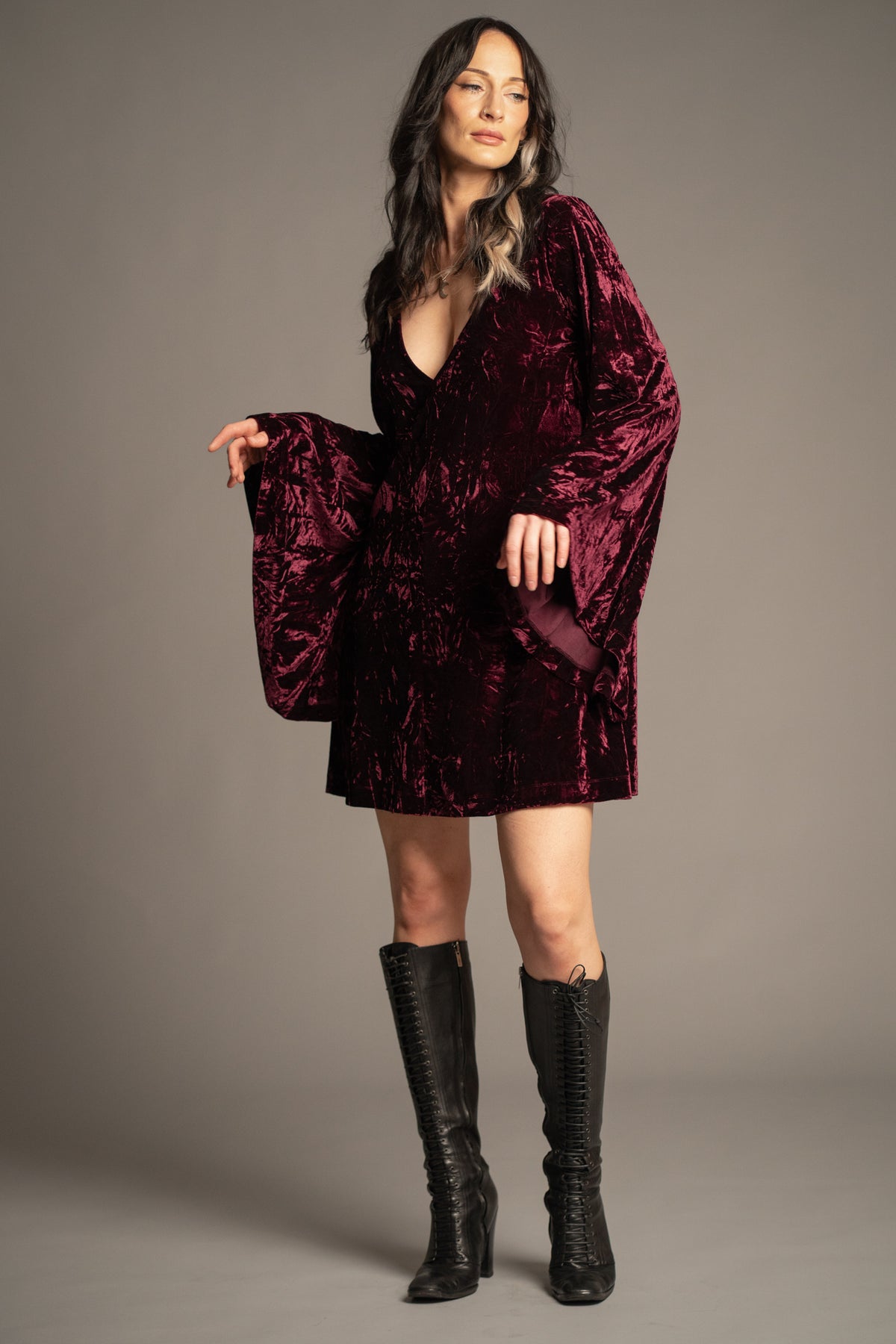 Sara merlot velvet mini dress with deep V-neckline, crushed velvet fabric and flowing bell sleeves front view